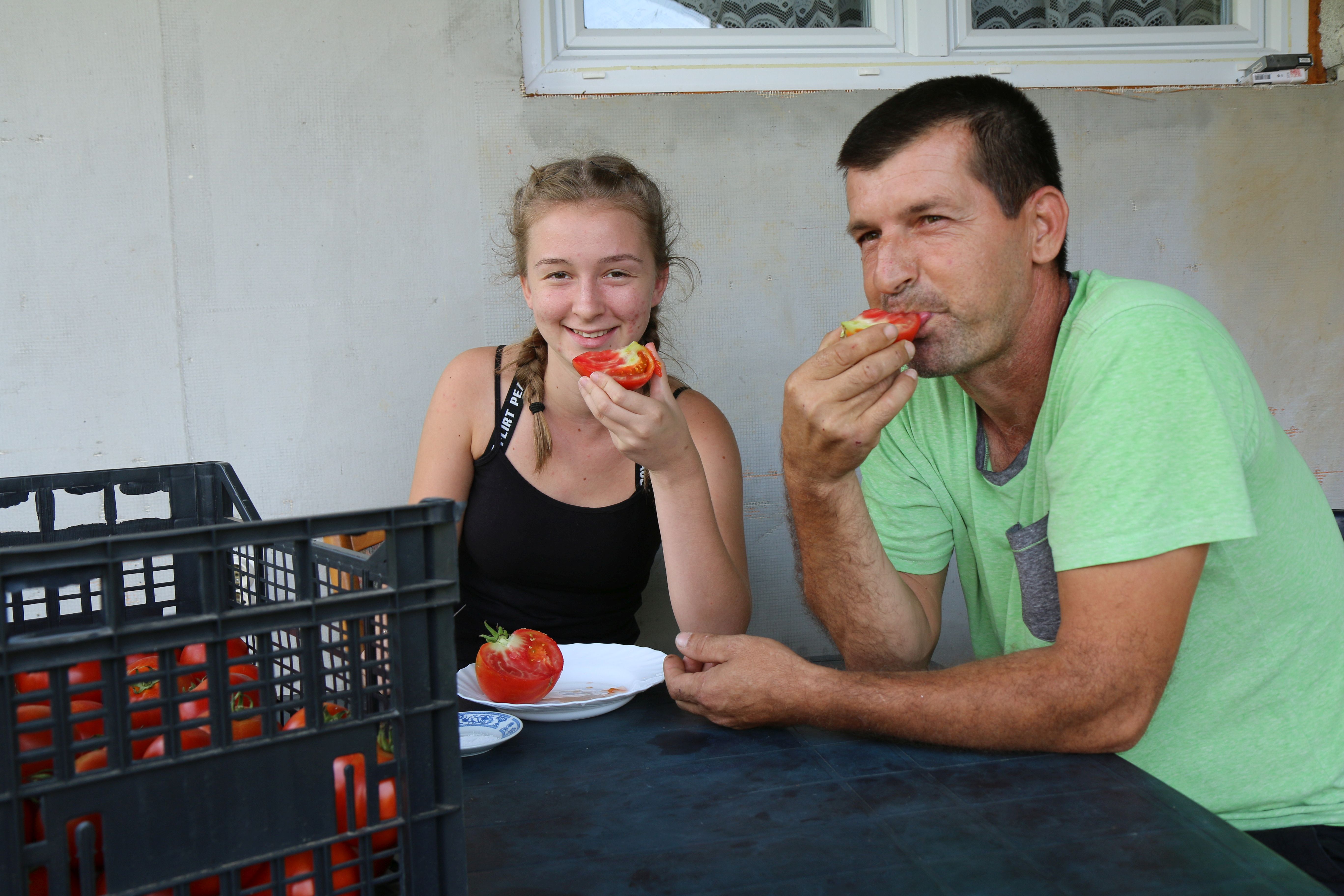 Šaban, landmine accident survivor, and his oldest daughter taste the fruits of their labor.