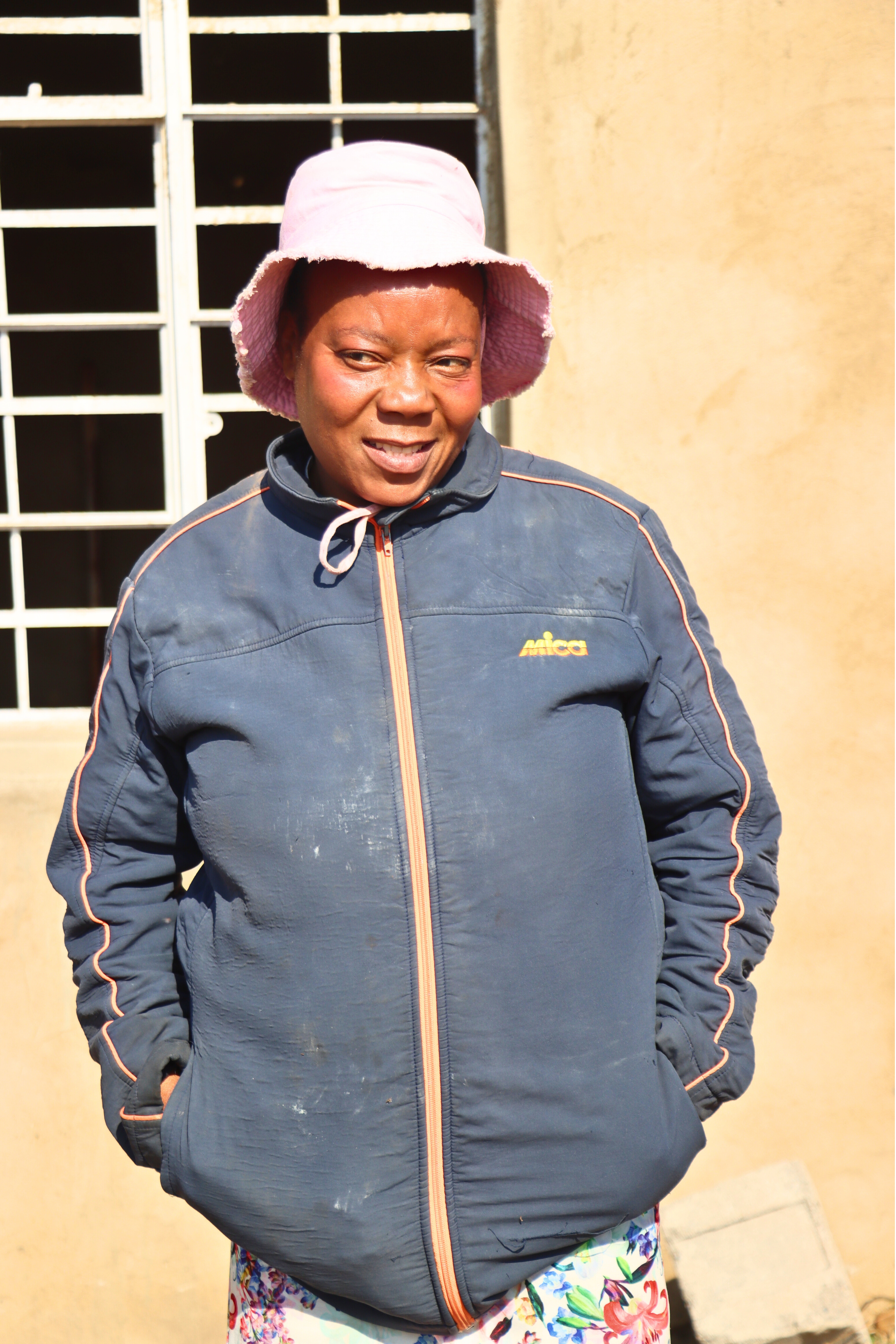 Nothando outside a structure her cooperative has constructed to use their offices.