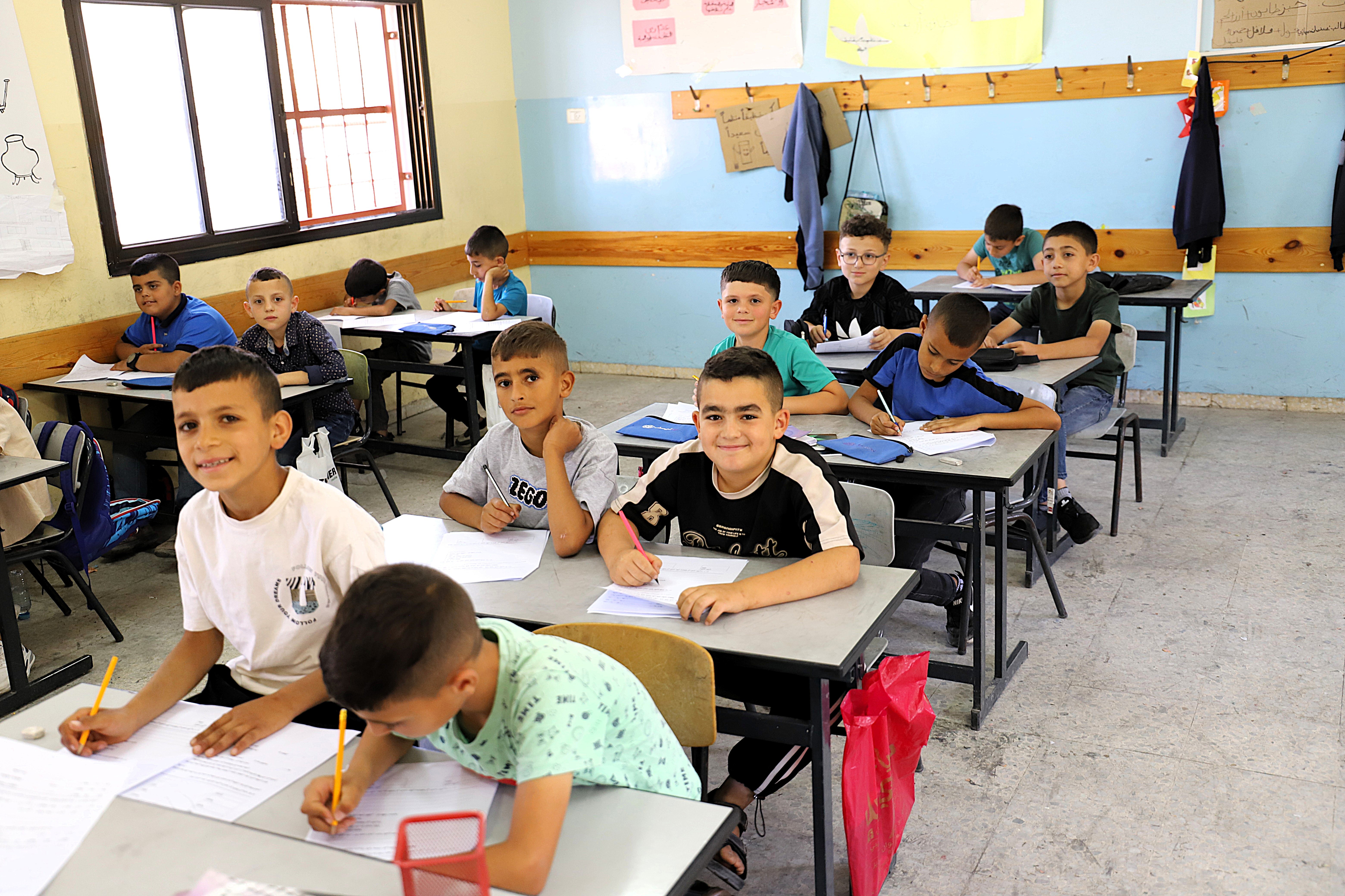 Students, including several recently displaced children from Jenin, attending a catch-up class at Deir Abu Daif Primary School for Boys
