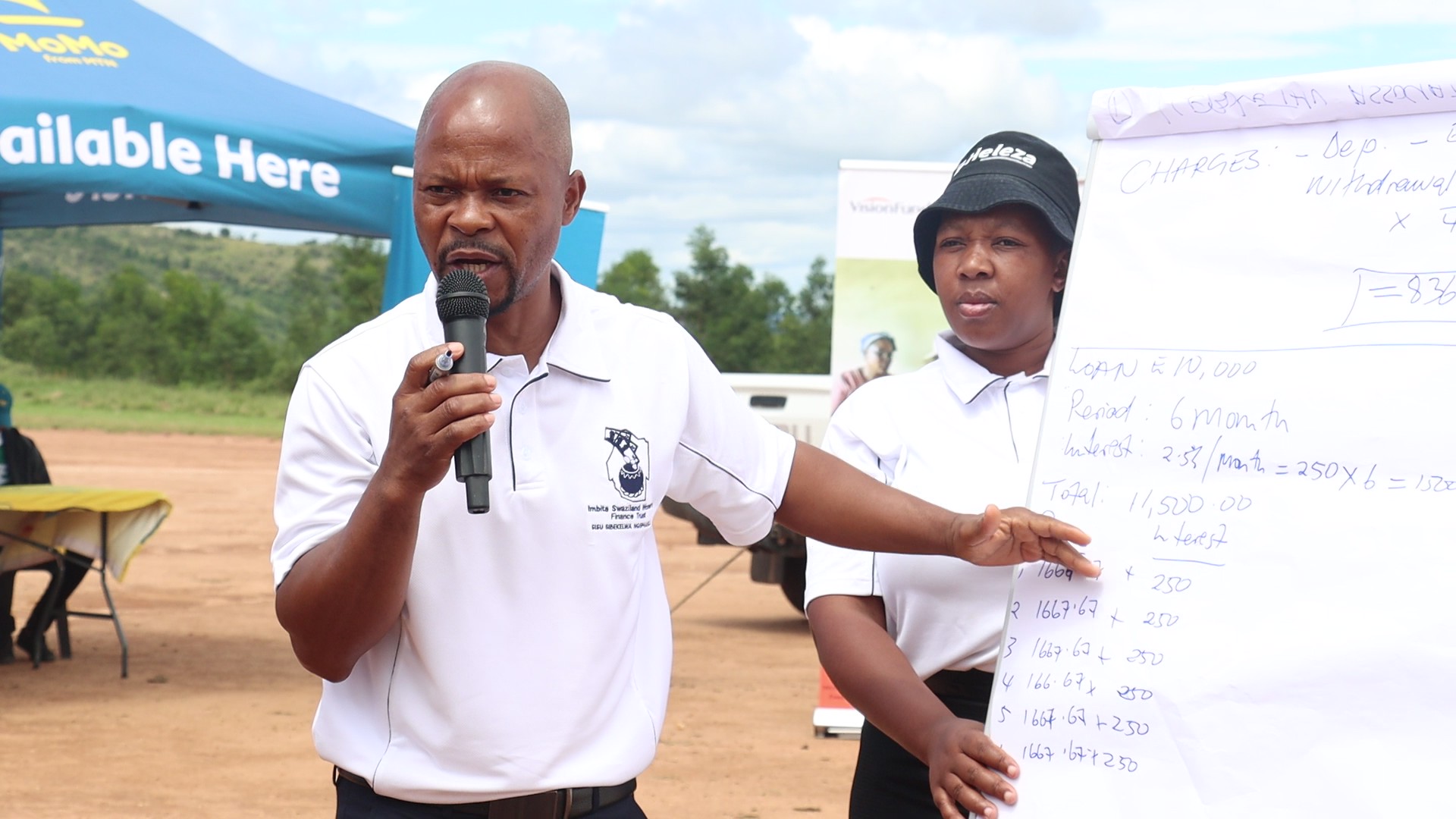 Representatives from Imbita Women's Finance Trust presenting their services to savings groups during the FAST Programme launch.