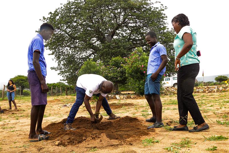 WVZ Operations Director, Khumbulani Ndlovu planting a tree at Gudyanga High School