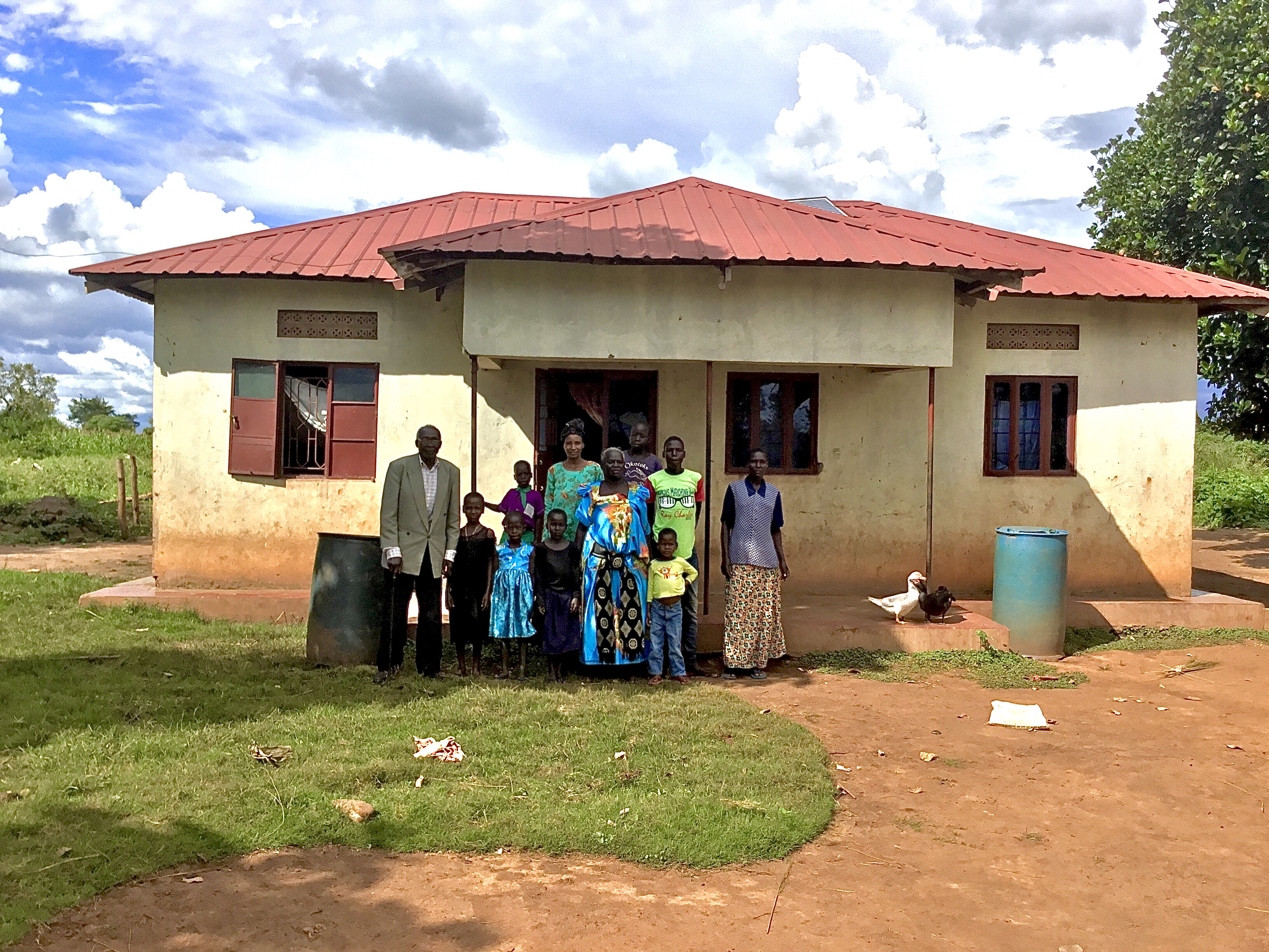 Akao with her family in front of her home