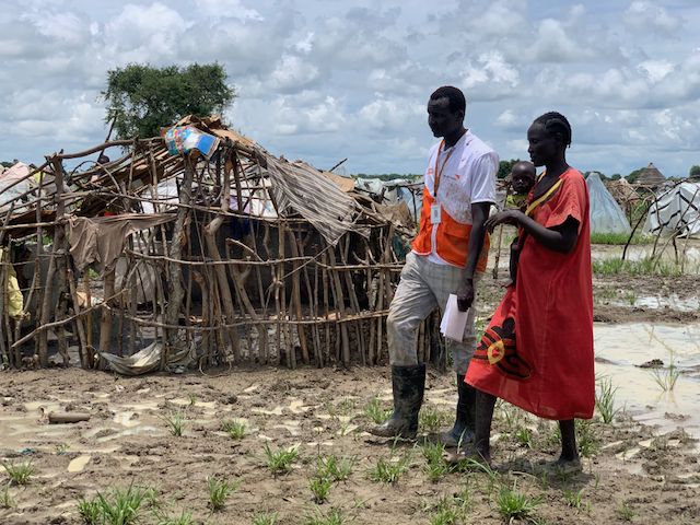 Aluel and a World Vision worker survey flooding damage