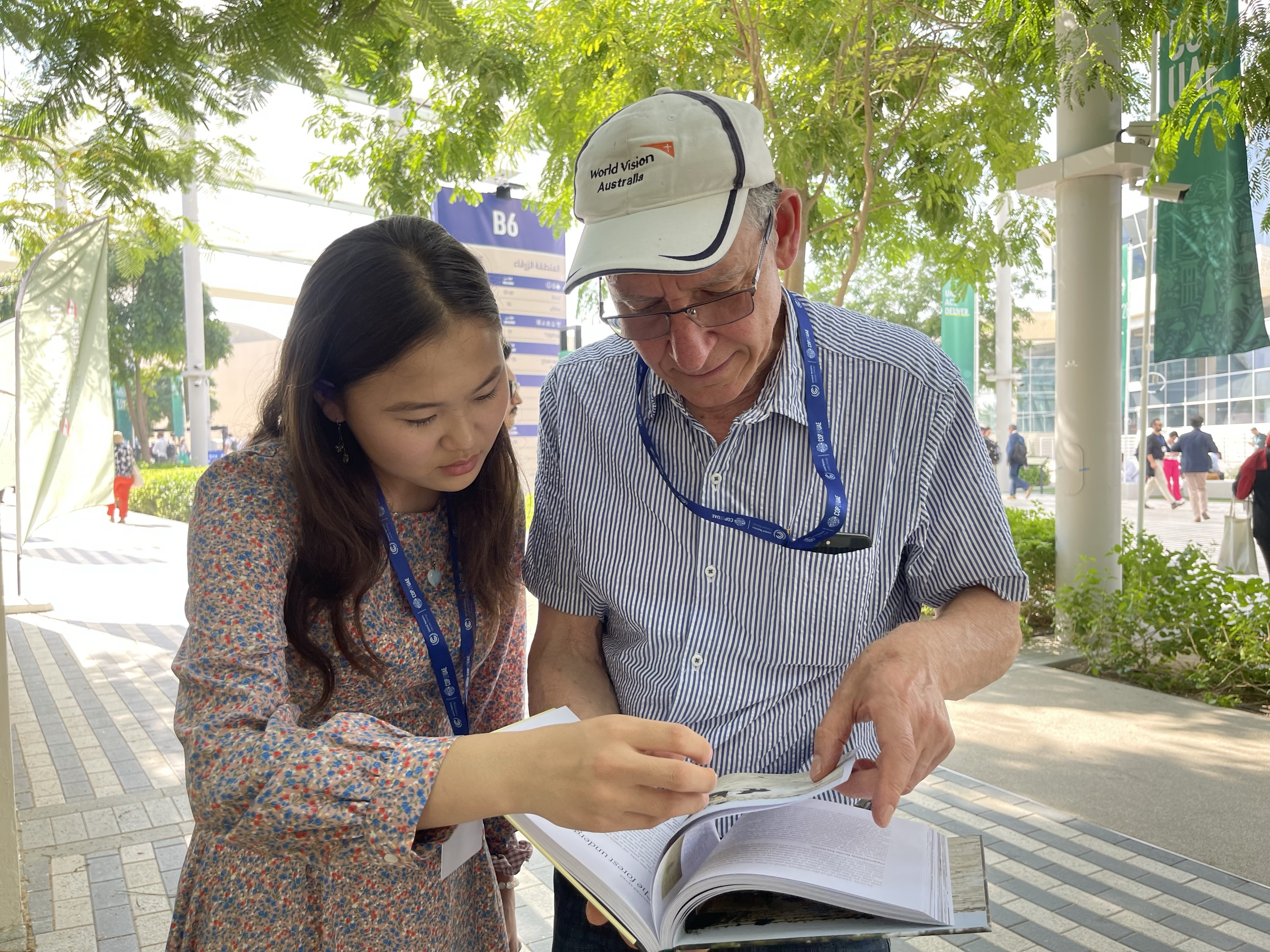 Nomin, a sponsored child and child leader, exchanges her views and sharing her experiences with Tony Rinaudo, World Vision's Natural Resources Management Specialist at COP28.