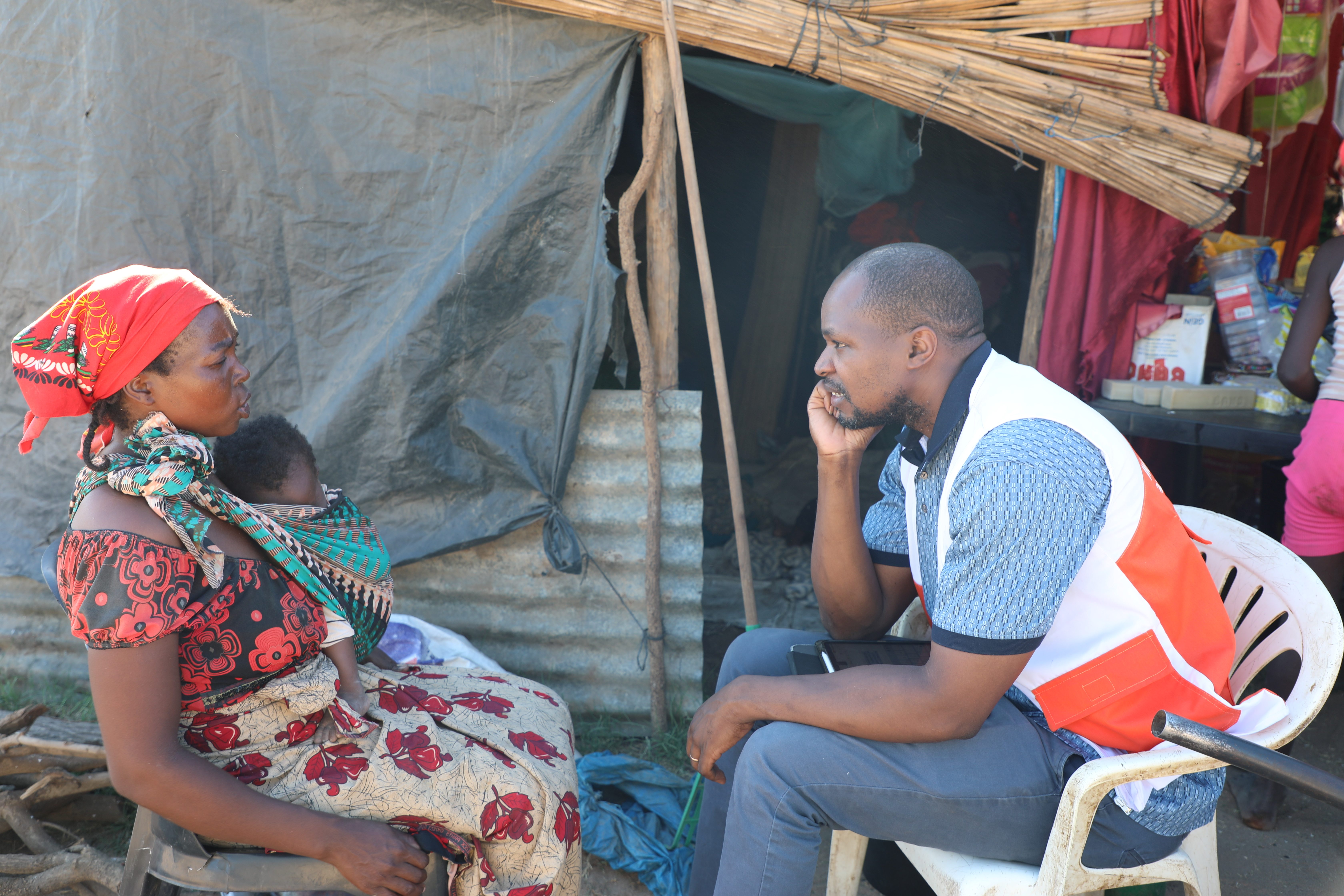 Filomena and a World Vision staff in a conversation about life at the accommodation center.