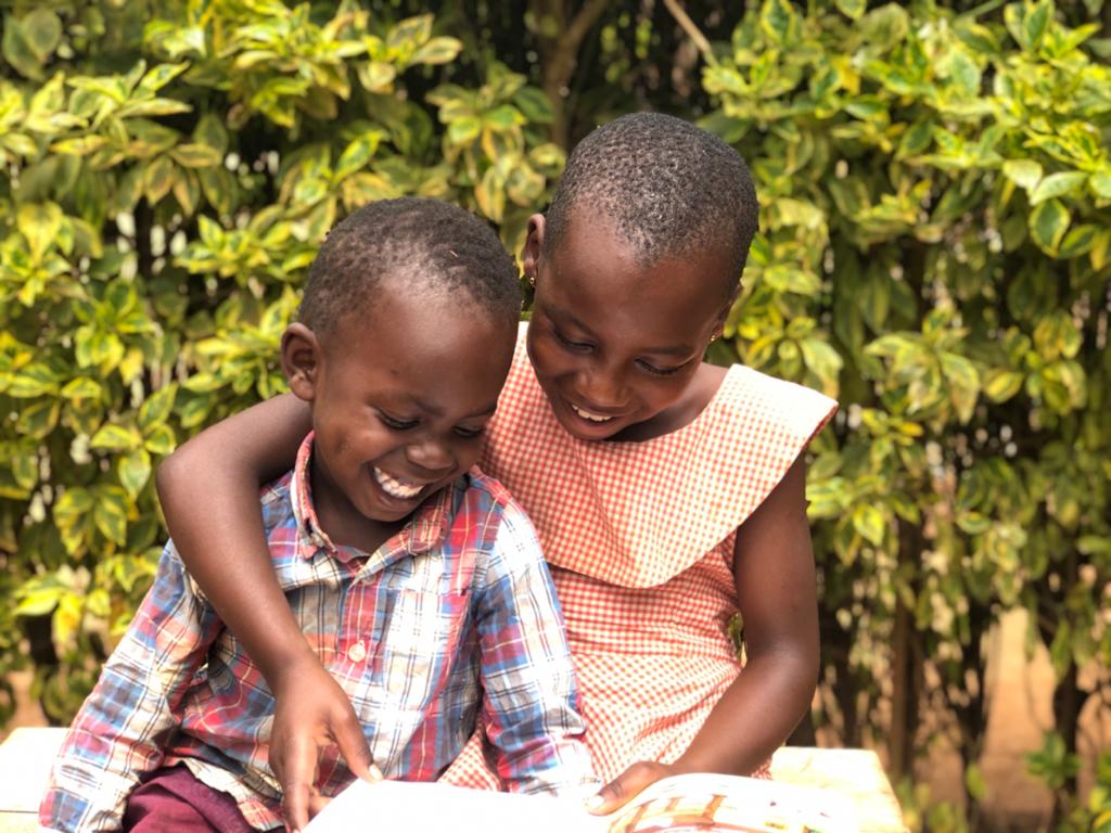 Jolly shares a book by reading to her brother