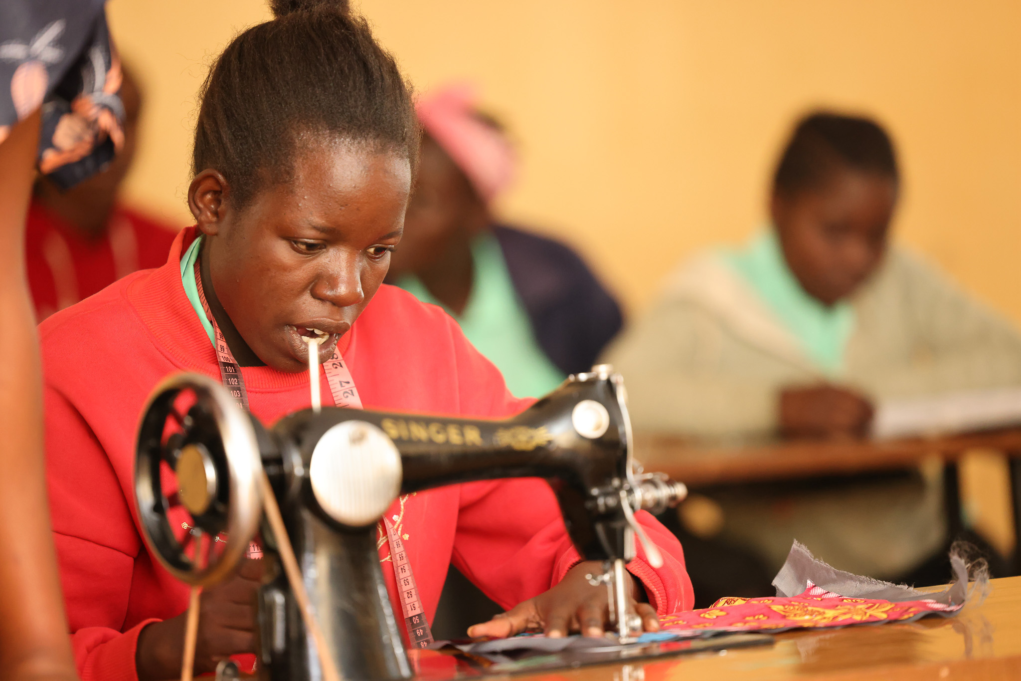 Joy Onyango is mastering dressmaking, a skill she’s determined to use to build a better future for herself © World Vision Photo/David Nderitu
