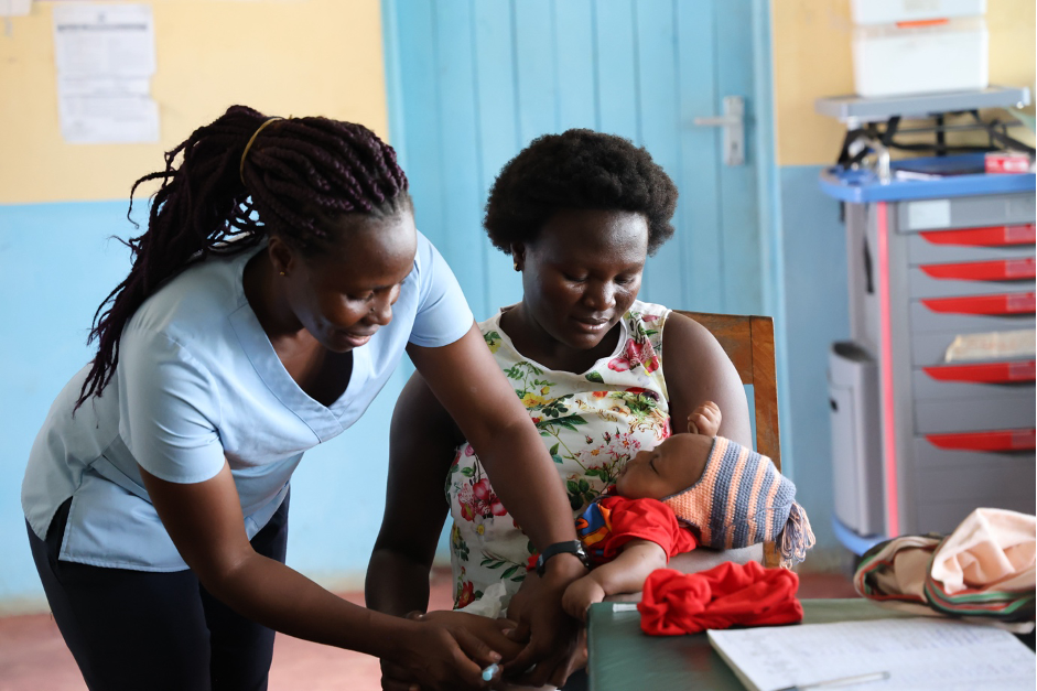 Selin Kache, a nurse at Rimarapera dispensary in Kilifi, is administering a vaccine to a child. The dispensary has improved access to medical services, leading to advancements in maternal and child health.