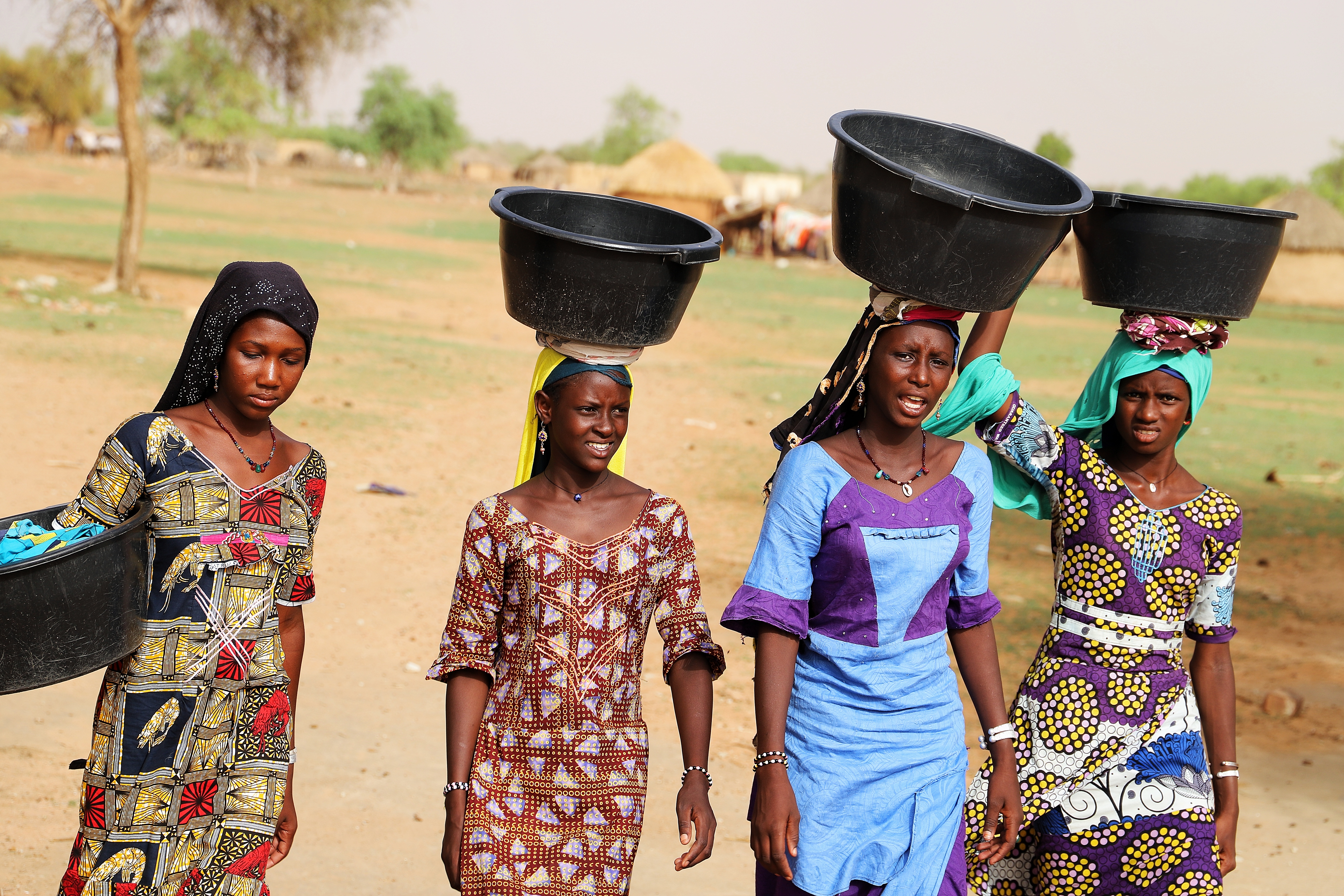 A teen (Coumba), and her friend going to look for water - Mauritania. 