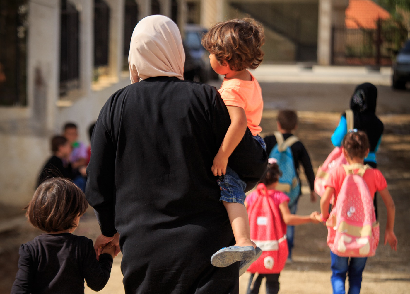 Forced to flee their homes in Syria, Abir walks her children and others to temporary school in Lebanon. Chris Huber/World Vision