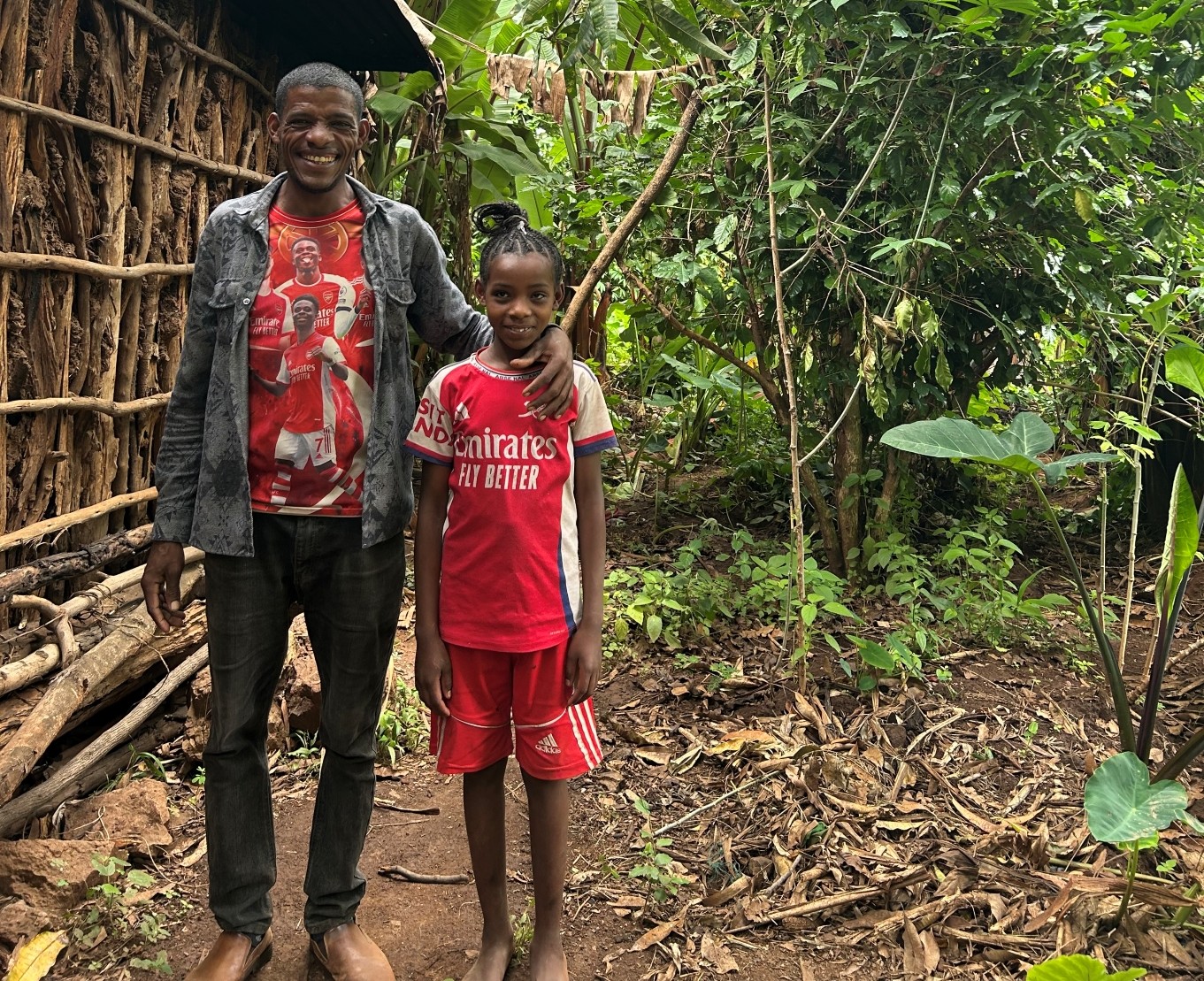 Abreham, a forest farmer living at the foot of the Humbo hills in southern Ethiopia, smiles at the camera with her daughter Lydiya.
