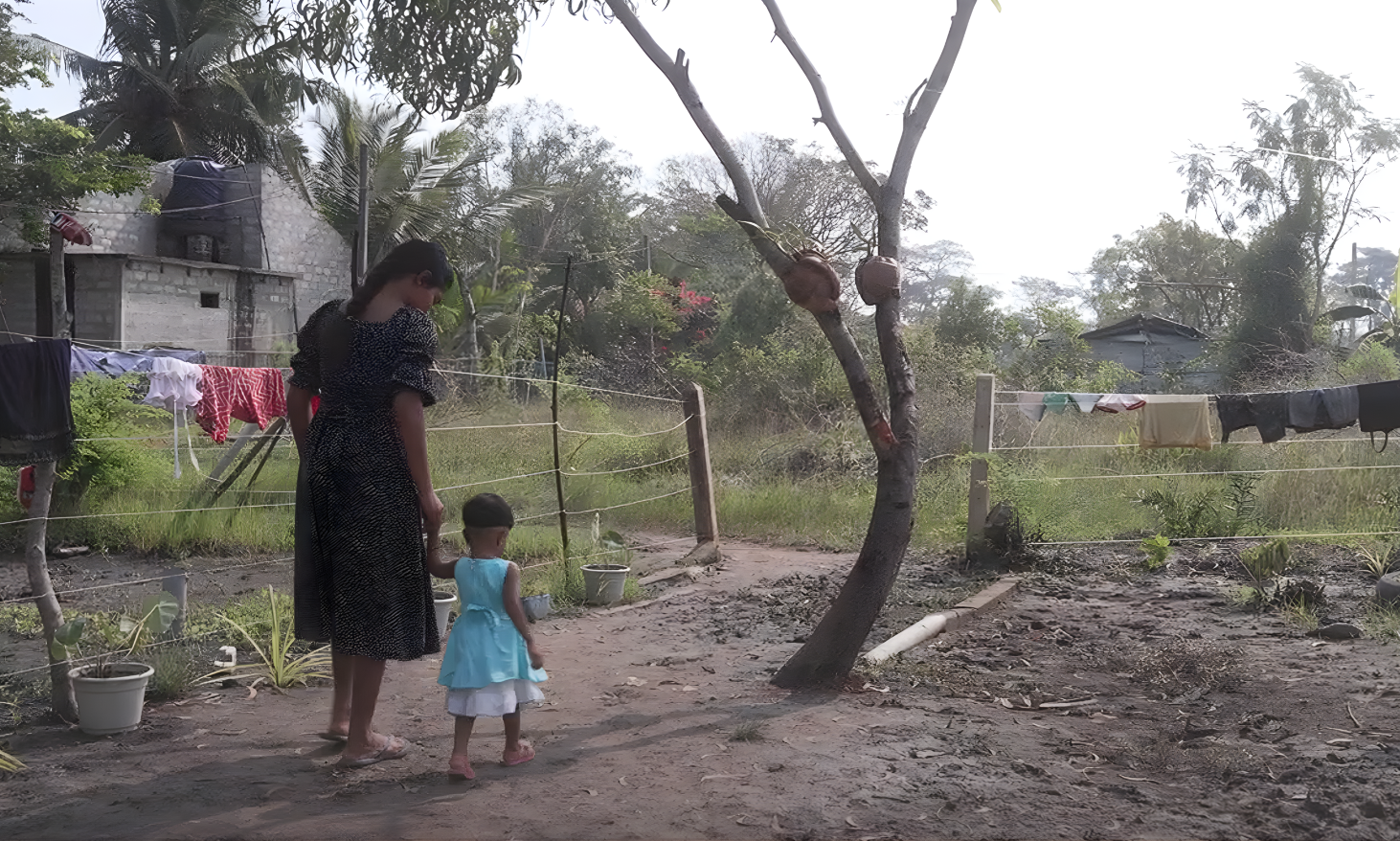 Lucia enjoys a quiet moment with her daughter after a long day of housework / Sri Lanka / 2025.
