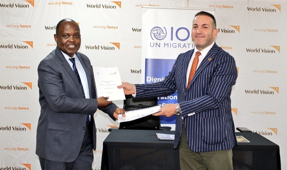 World Vision Kenya Acting National Director and the IOM Deputy Chief of Mission pose with the signed MOUs at the World Vision Kenya Office