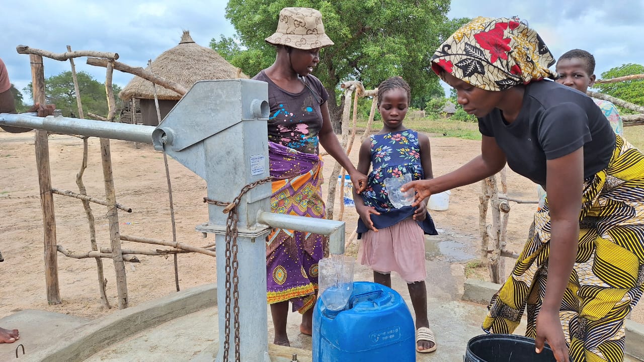 Women and girls bringing water at a new borehole 