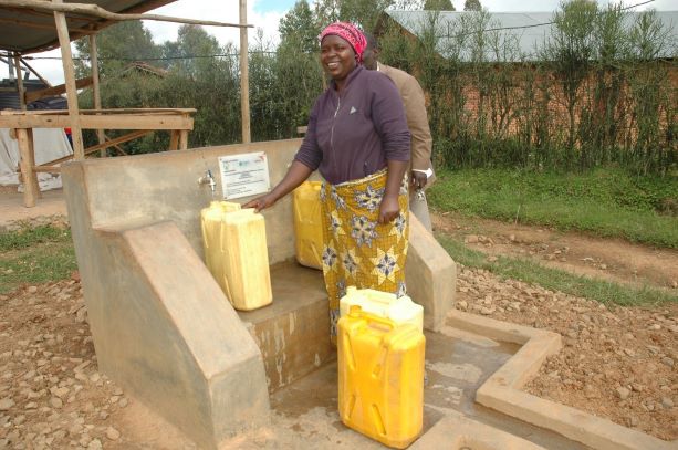 Marie Grace happily fetching water from one of World Vision's established water points