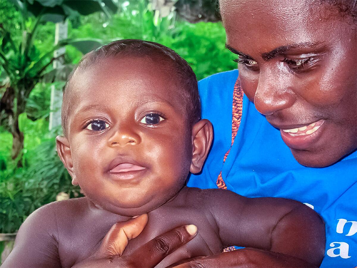 Mother holding her four months' old baby, Lincoln.