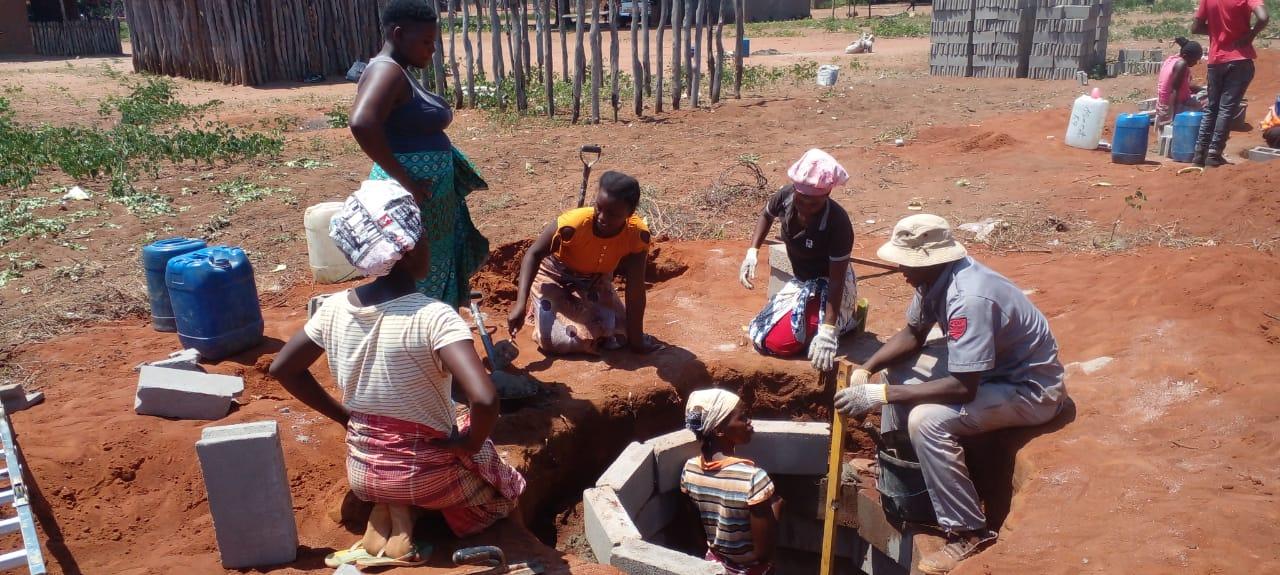 Women building latrines as part of the WASH project lead by World Vision Mozambique