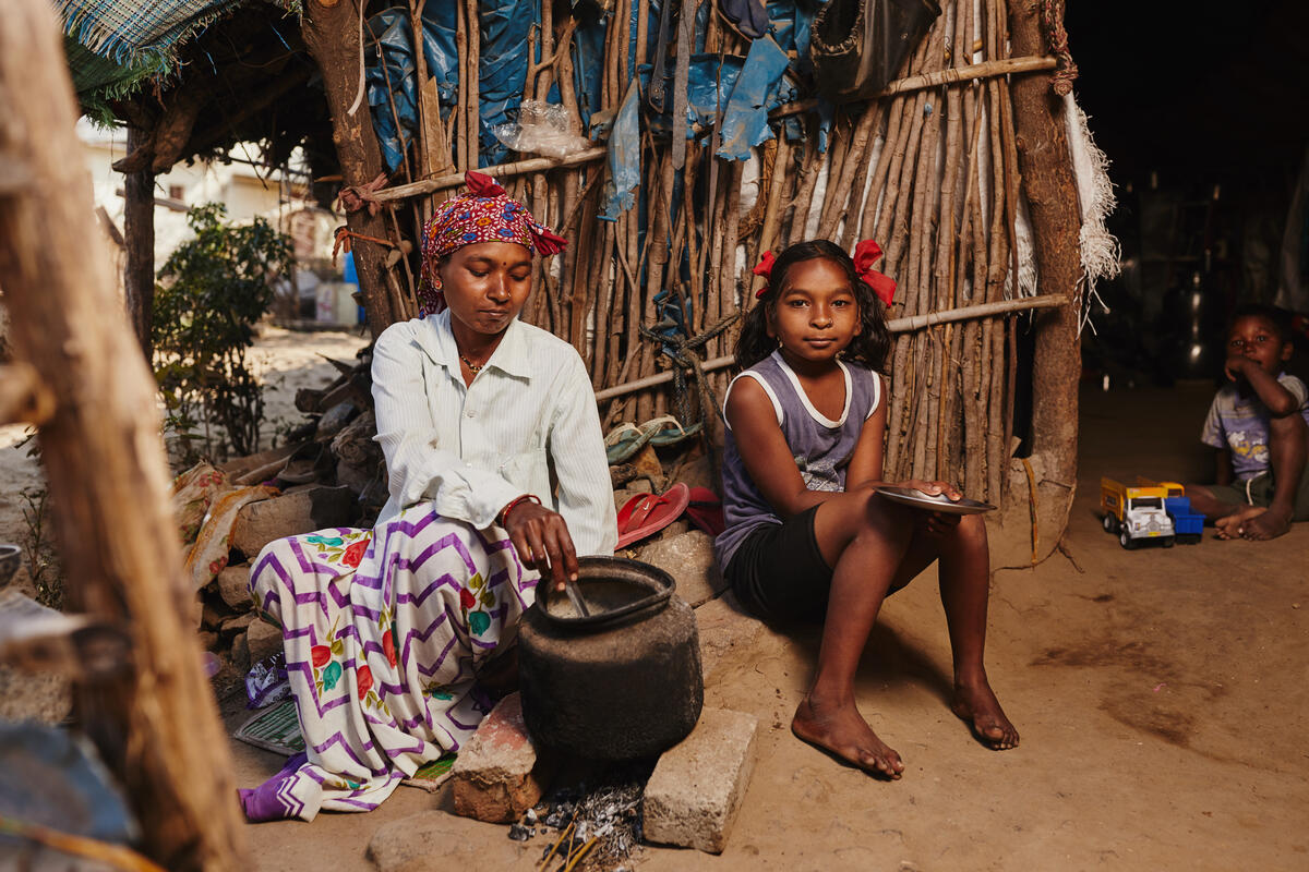 Mother and daughter preparing food in a kitchen in India.