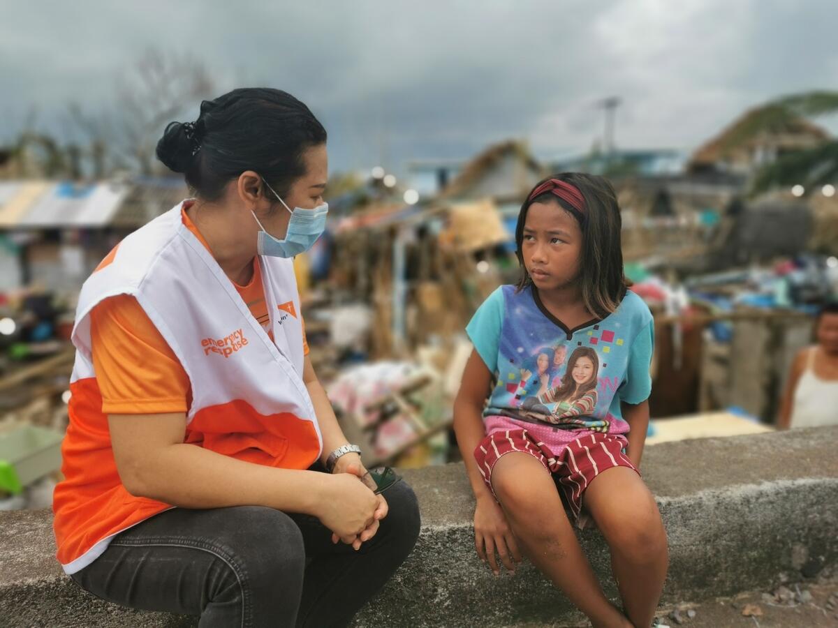 A world Vision staff with a child who has been impacted byTyphoon Goni in the Coastal Area.
