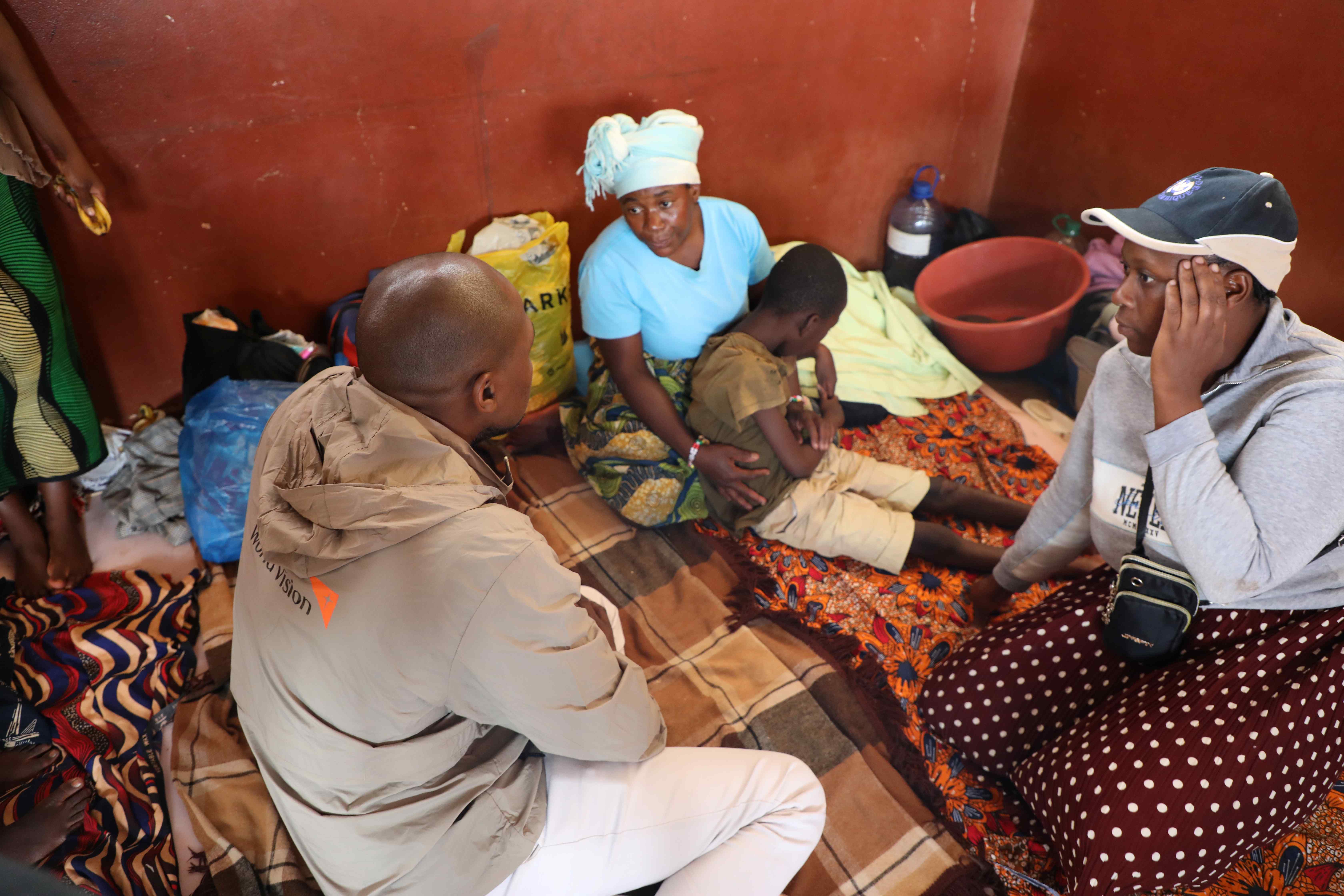 In the center, Elsa, the mother of 12-year-old Jaime, a child with disability, explains how she deals with double impact at the accommodation center.