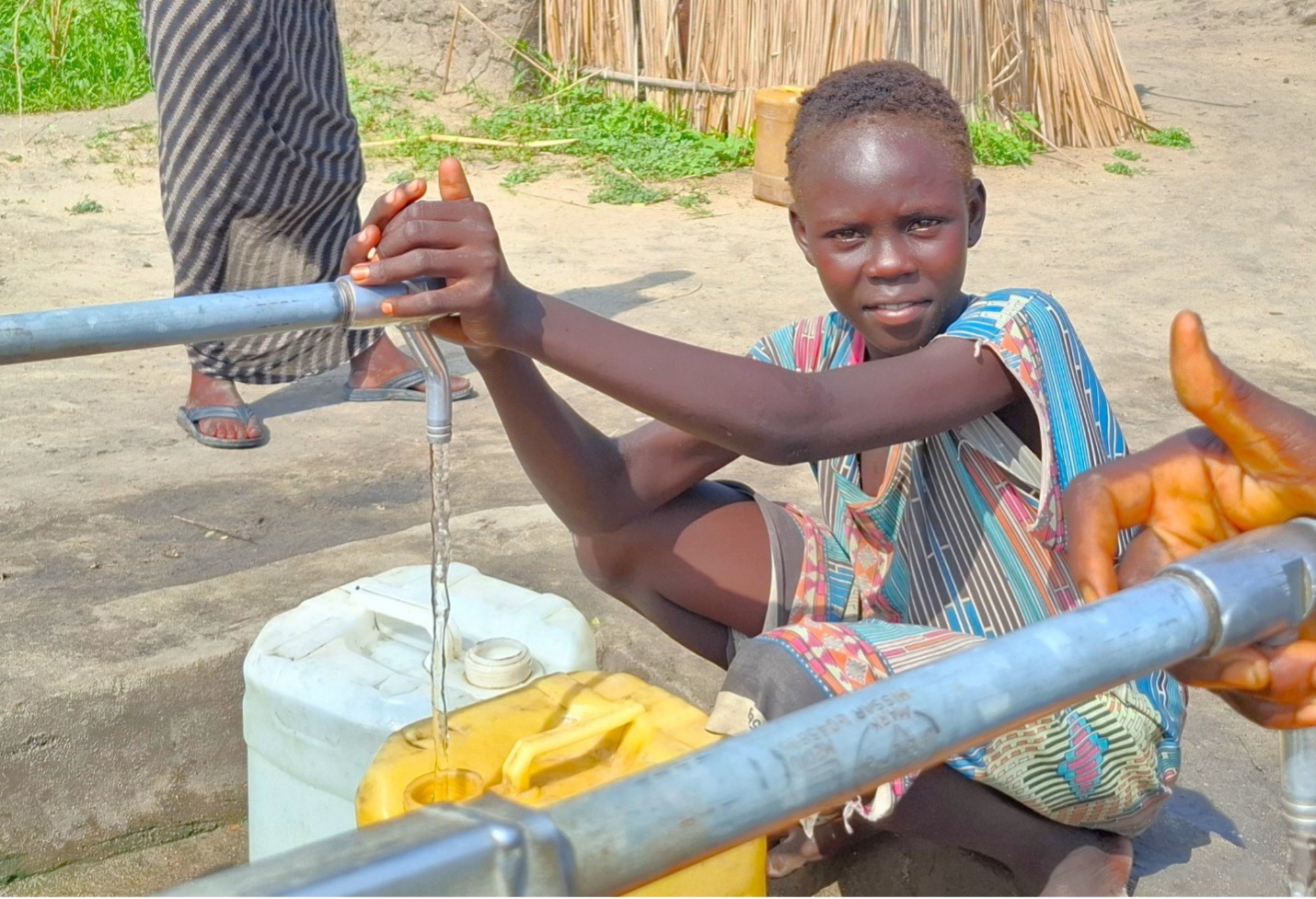 Nura, Nasime’s daughter filling water