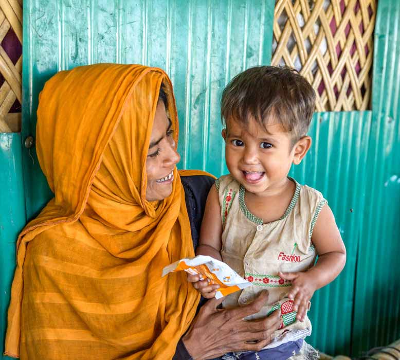 MALNUTRITION PREVENTION: Jaheda celebrates 2-year-old Minara’s recovery from moderate acute malnutrition after she received treatment at World Vision’s feeding centre.