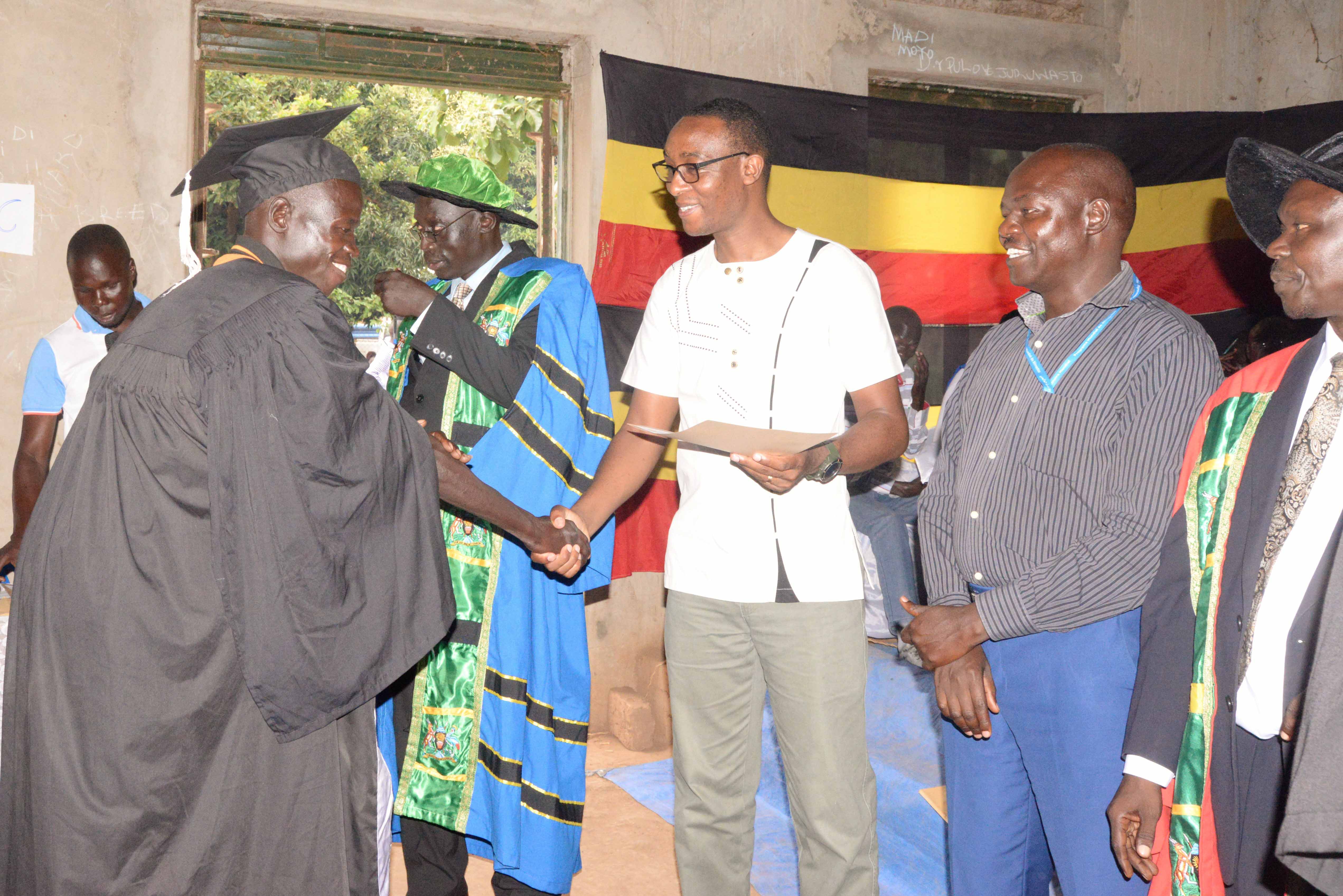 One of the beneficiaries receives a certificate of completion from a World Vision staff