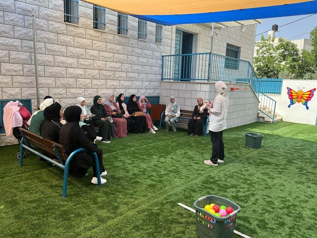 Palestinian mothers take part in a PD session