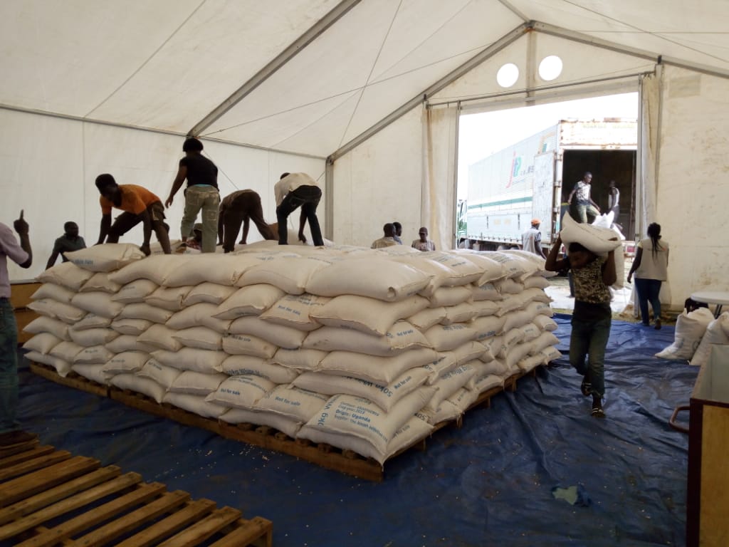 Food being offloaded from the truck to be stacked in the rub hall (warehouse)