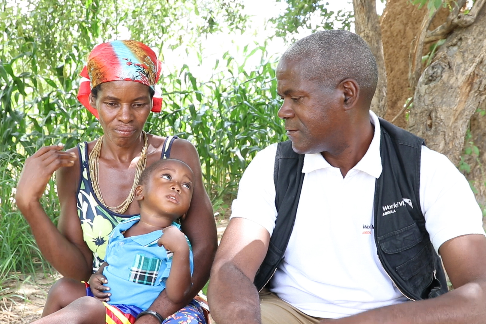 World Vision Nutrition Supervisor, Isais Ricardo, with Paulino and his grandmother Cordelia.