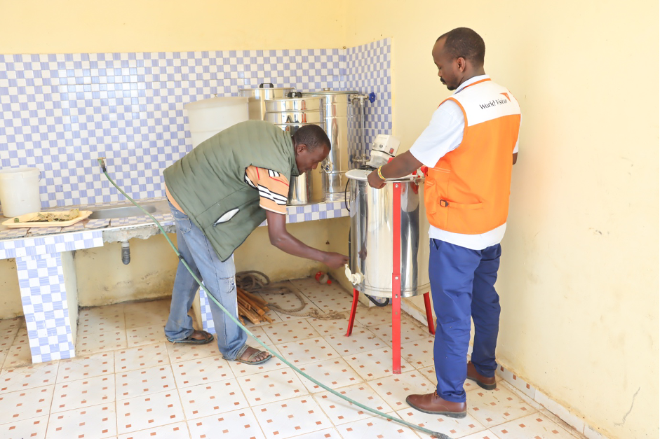 Peter Emuria, a bee farmer supported by the IMARA programme demonstrates how a honey-processing equipment works