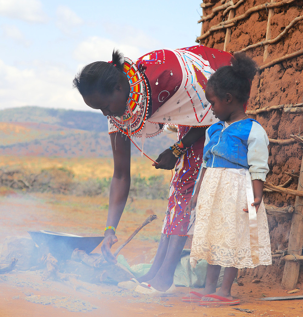 Petronila using the rudimentary three stone fire that emits so much smoke which pollutes the environment and causes adverse health effects. ©World Vision Photo/Wesley Koskei