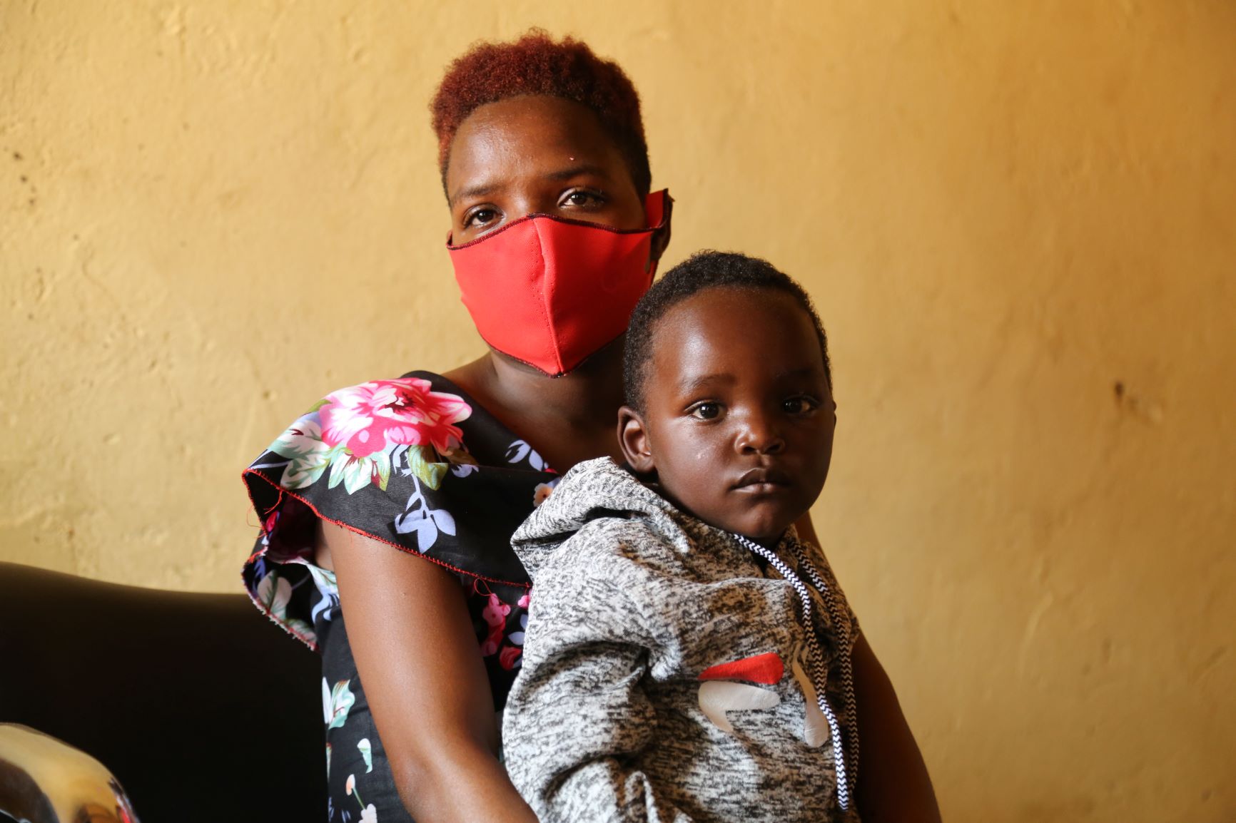 Janviere poses for a photo with her son