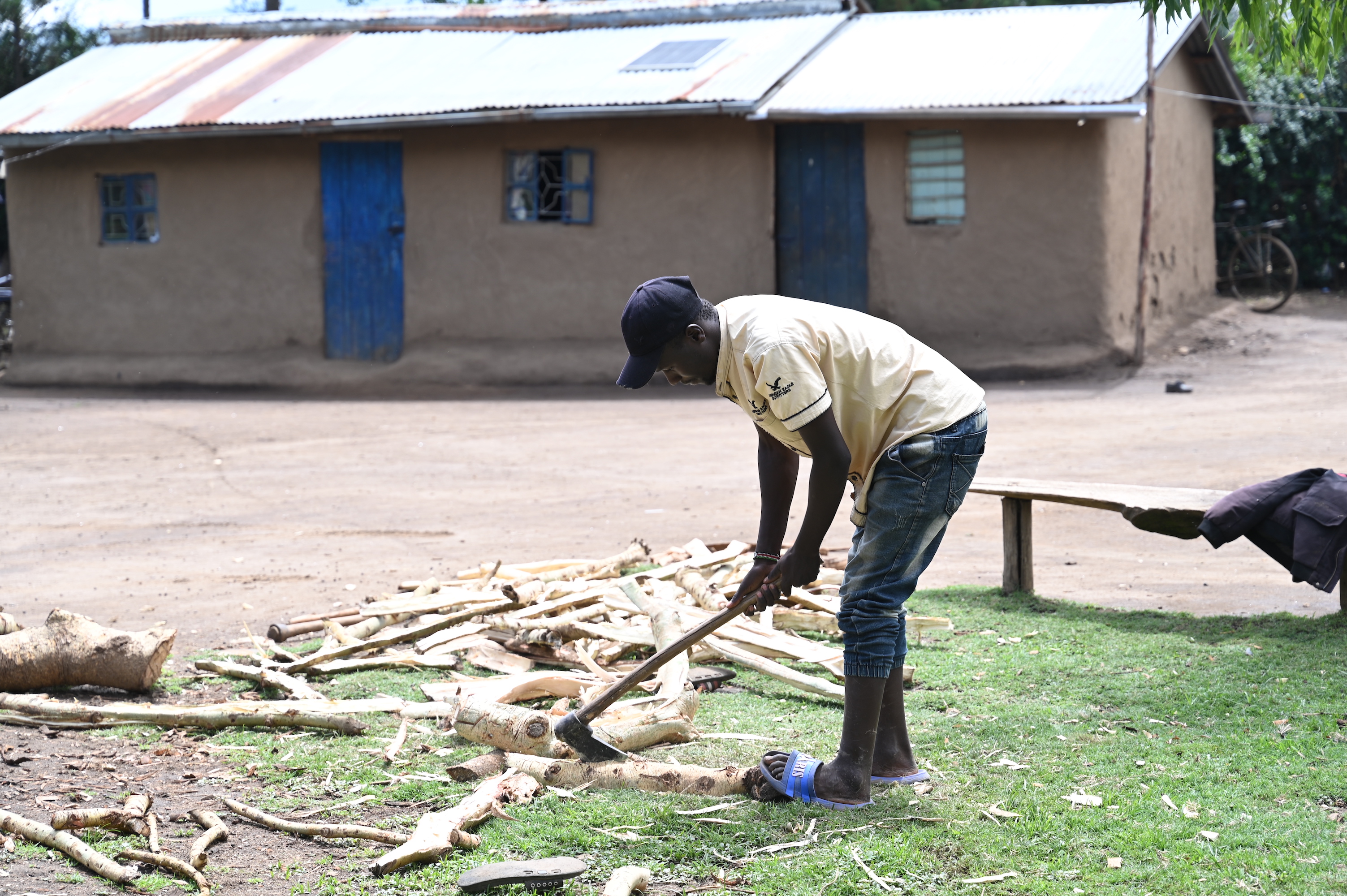 Musa’s son, Peter,  splitting firewood. 