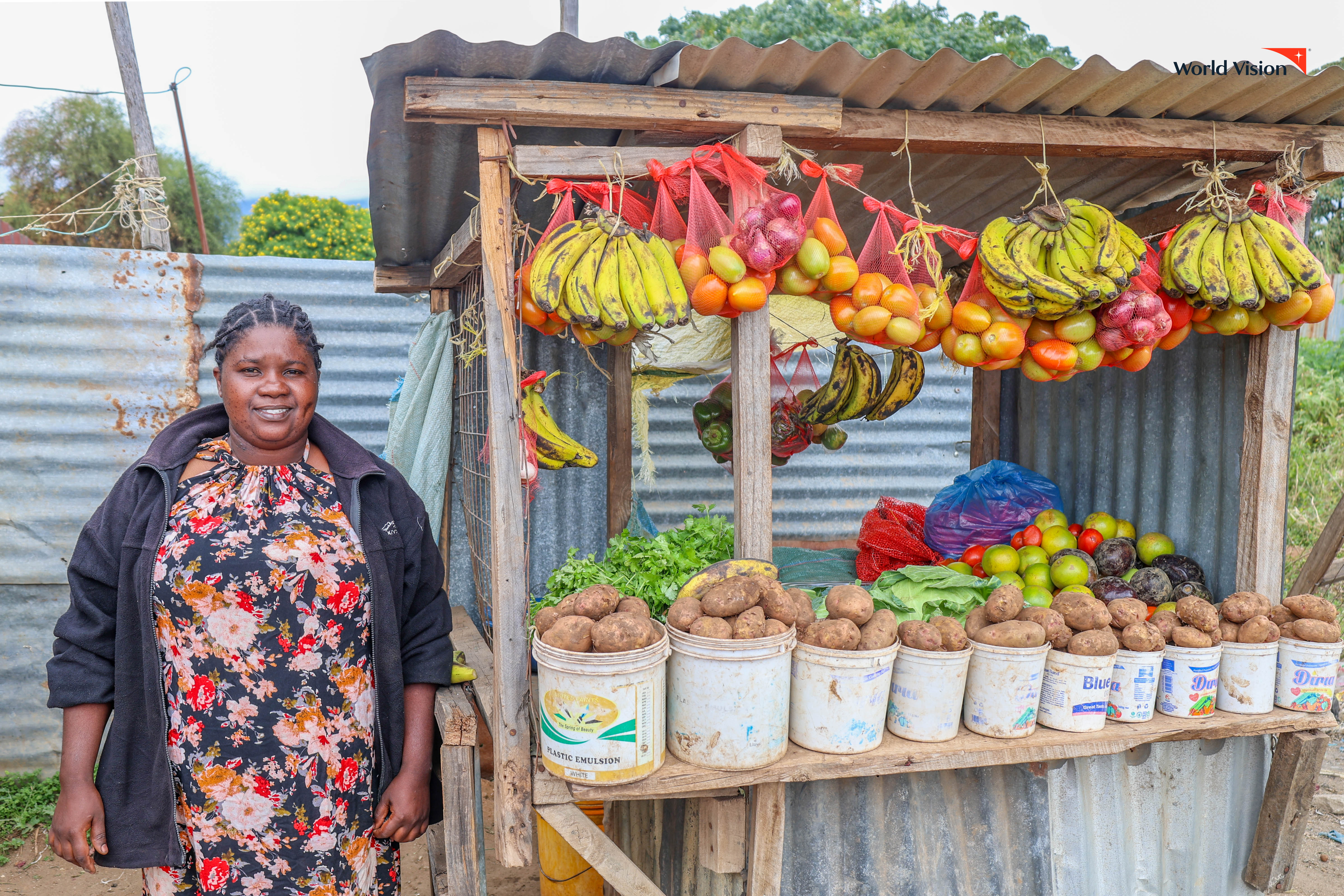 Felister Mwikali, stands beside her grocery stall, the humble business that now pays her children’s school fees and secures their future, thanks to the support and savings discipline she gained through the Angaza Neno Saving for Transformation group. ©World Vision Photo/Mirriam Kioko