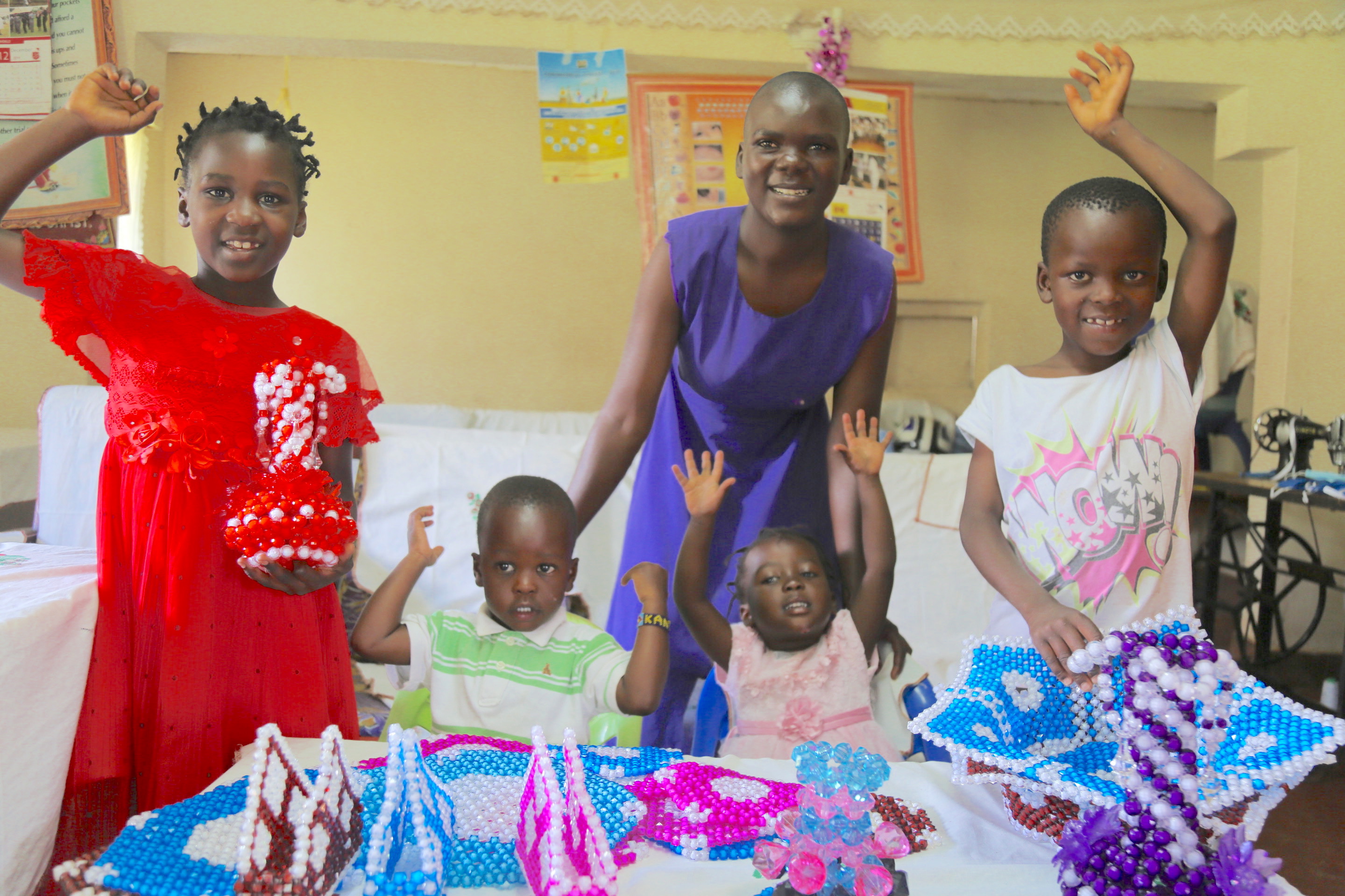 Anne’s children displaying the ornaments . During their free time, the children help their mother to design them for sale.