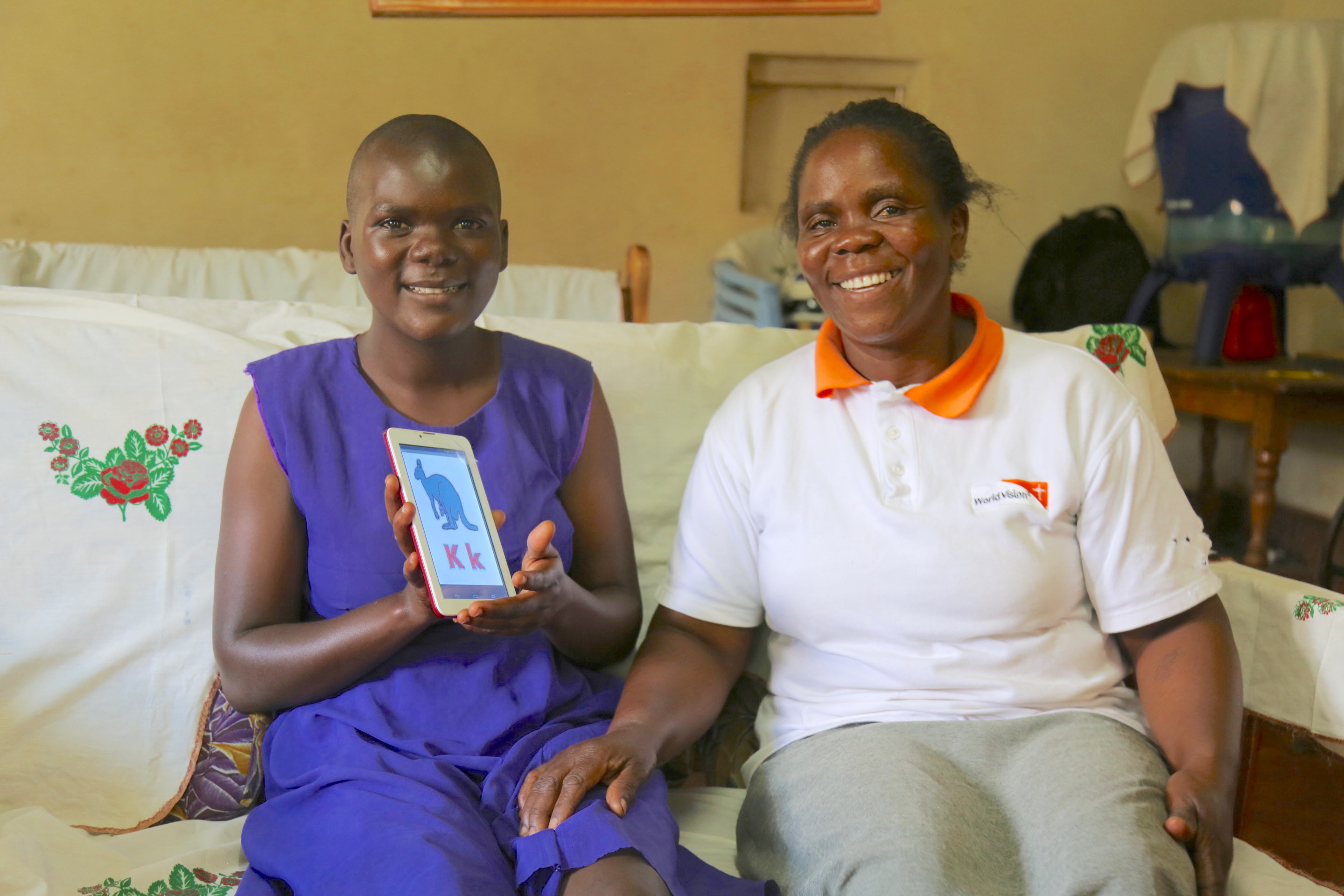 Anne with her daughter Sylvia Rengo who is mentally challenged displaying the installed application she uses to study on her mother’s tablet