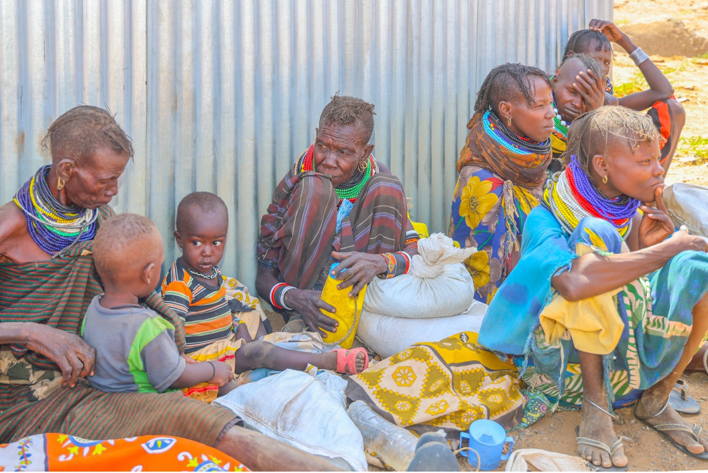 Mothers and children sit with their waiting for relief assistance distributed through the partnership between World Vision Kenya and the World Food Programme in Nadunga Village, Turkana North. ©World Vision Photo/Mirriam Kioko