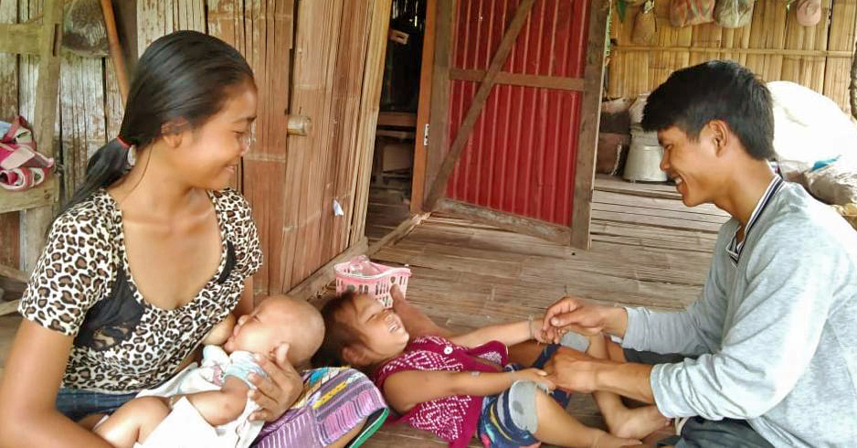 Airnoy's family is now thriving in Savannakhet province. While Oad plays with his daughter, Lamphane is able to breastfeed her 3-month baby.