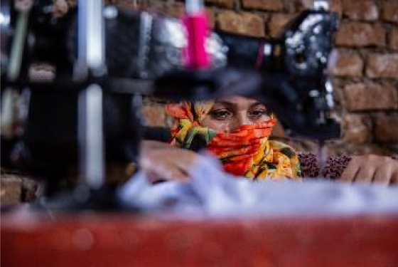 Fatima with a veil on using a sowing machine