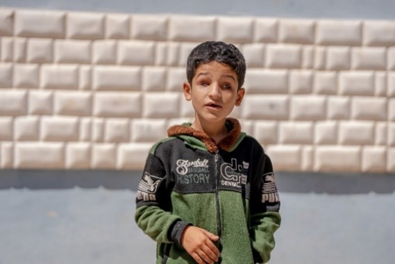 Khaled and his brother playing in the yard of the camp. World Vision Syria Response - Zaher Jaber