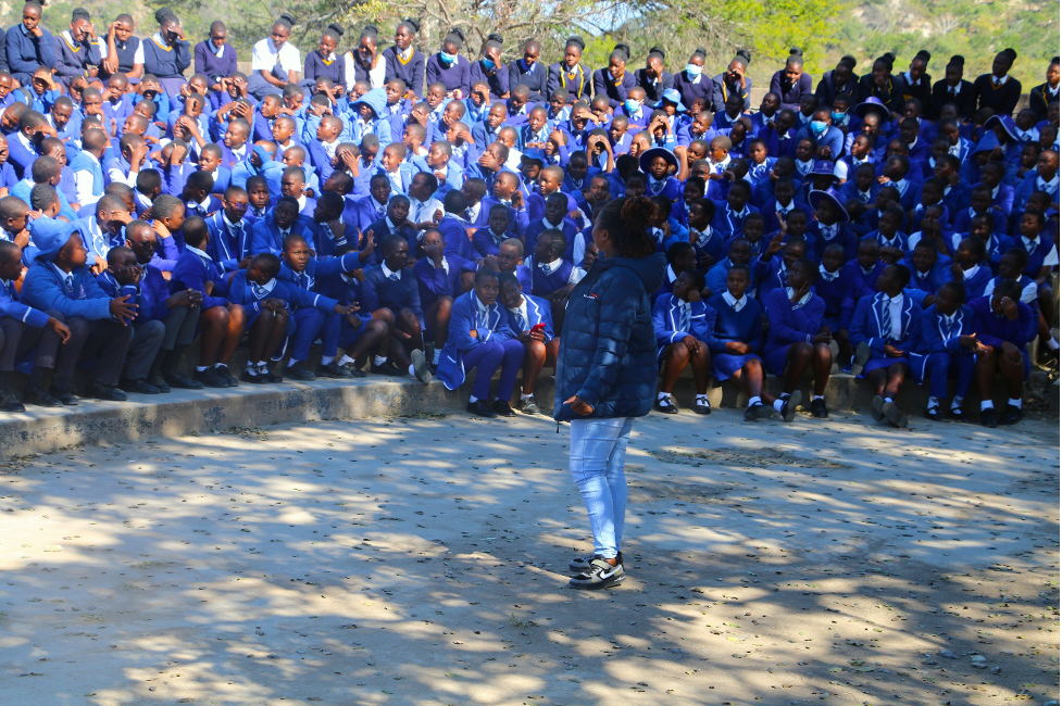 Prudence addressing the school at an assembly point