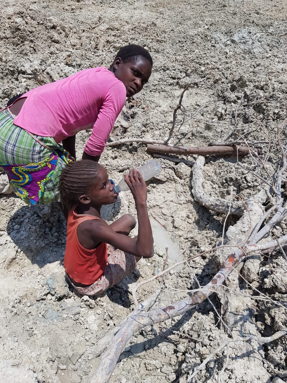 A child drinking water from an unsafe source