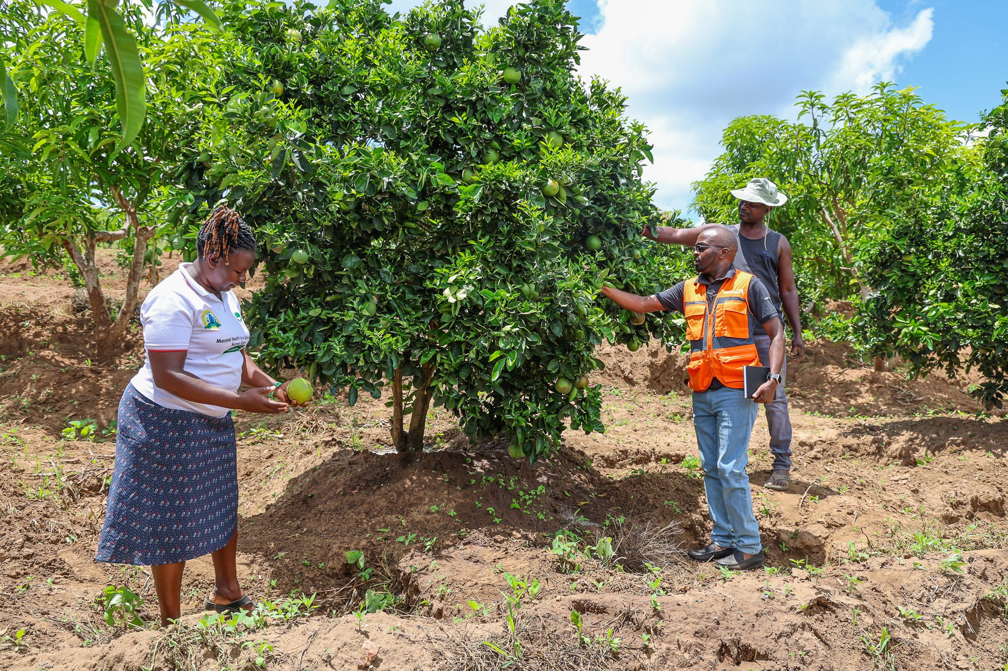 World Vision Kenya's Cedric Karani visits Winfred Musembi and her husband at their climate-smart farm in Kasooni Village, Makueni County. © World Vision Kenya/ Jared Ontobo