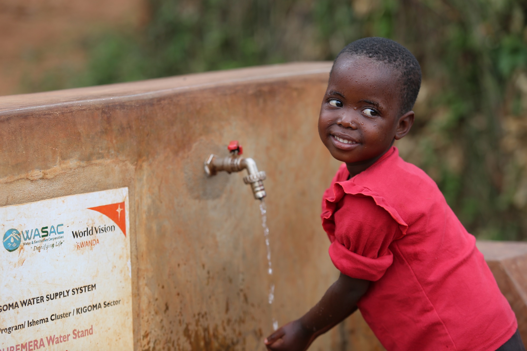 Girl washing her hands with piped water