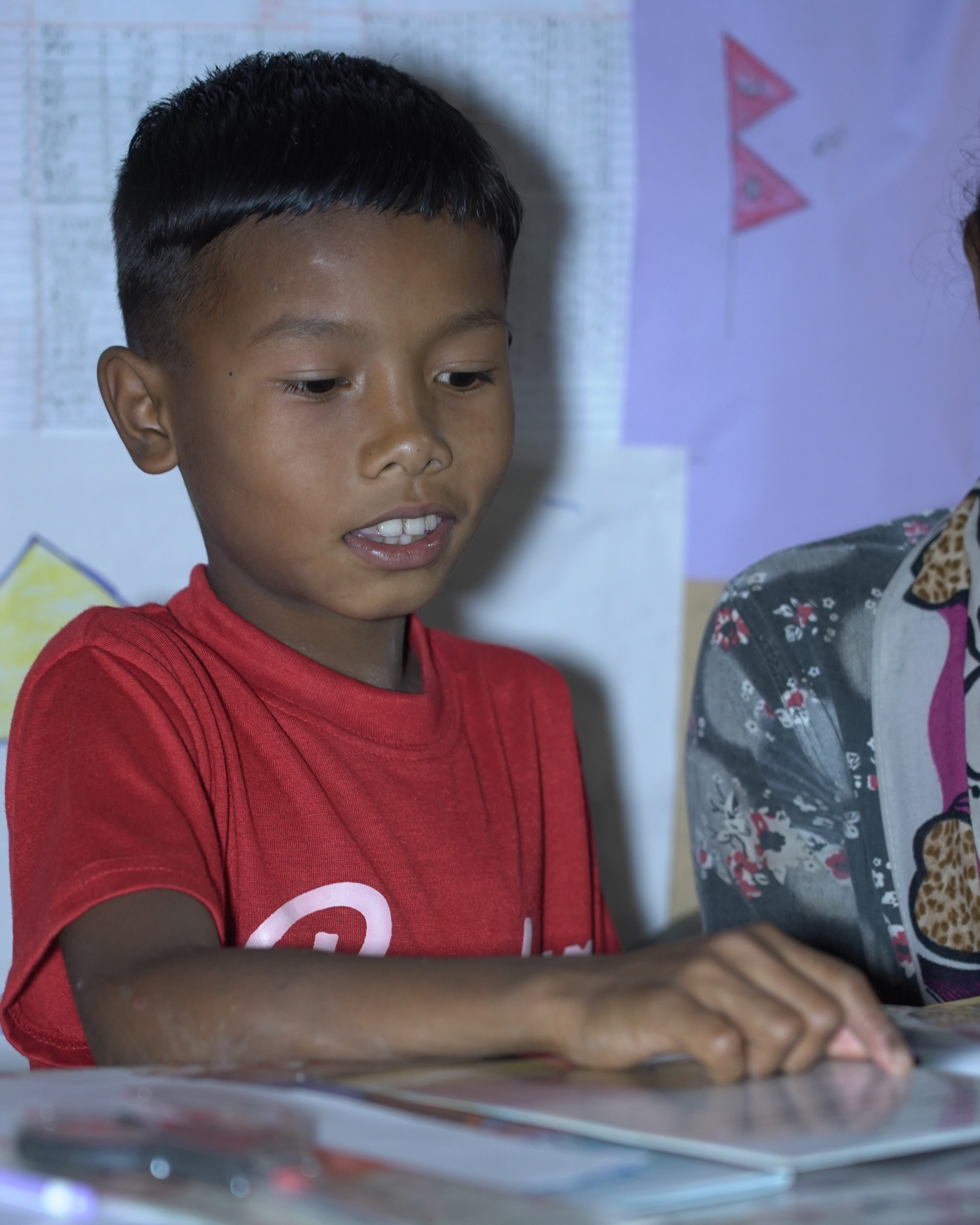 Biyes reads a storybook to his mother