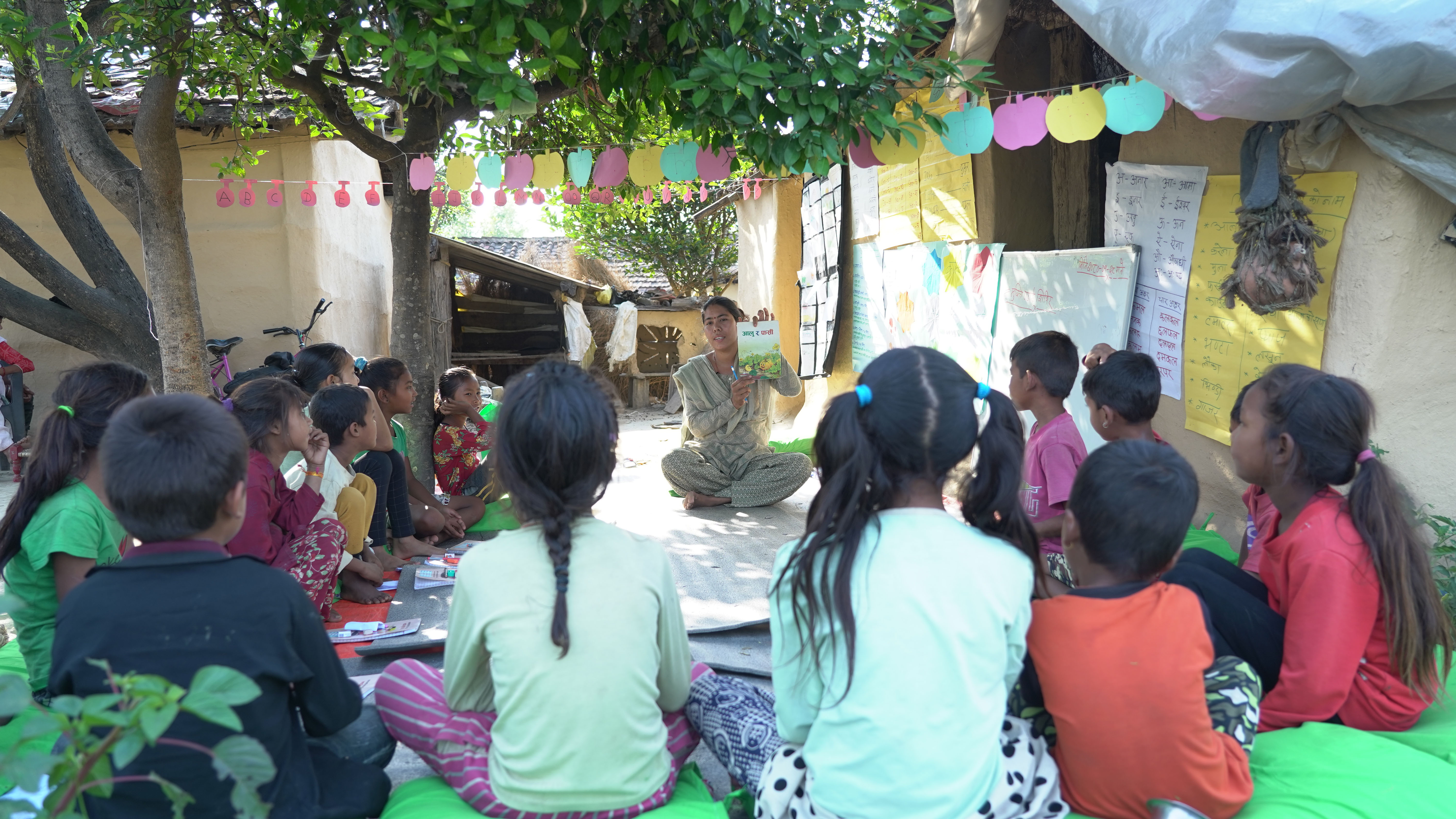 Children from a reading camp learn about a story book.