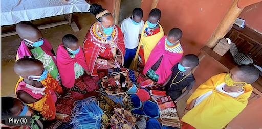 Girls receiving cloth pads made for them by the Chui Mama Women's Group.