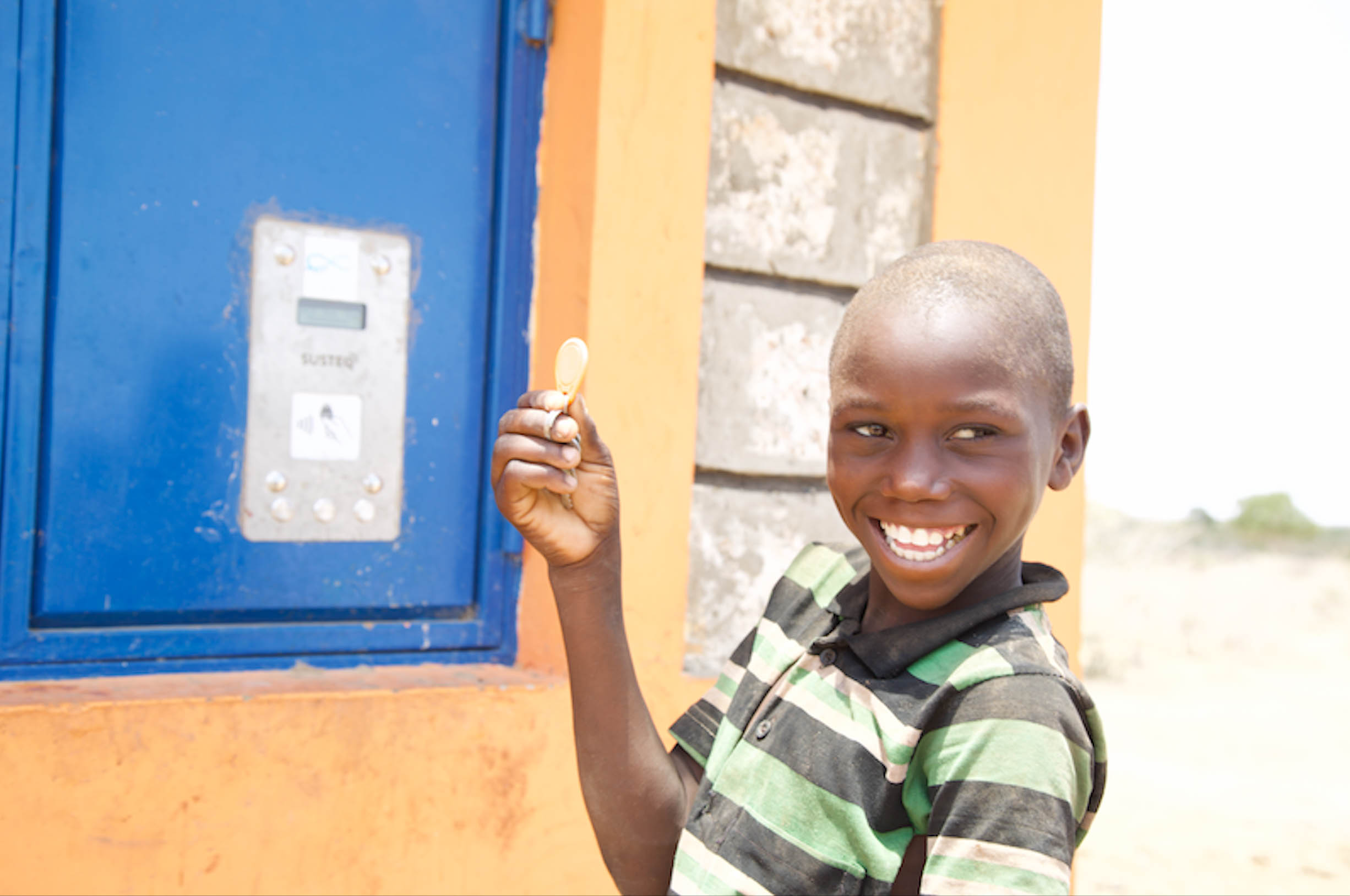 Heri displays a chip that he uses to access water for domestic use and for animals