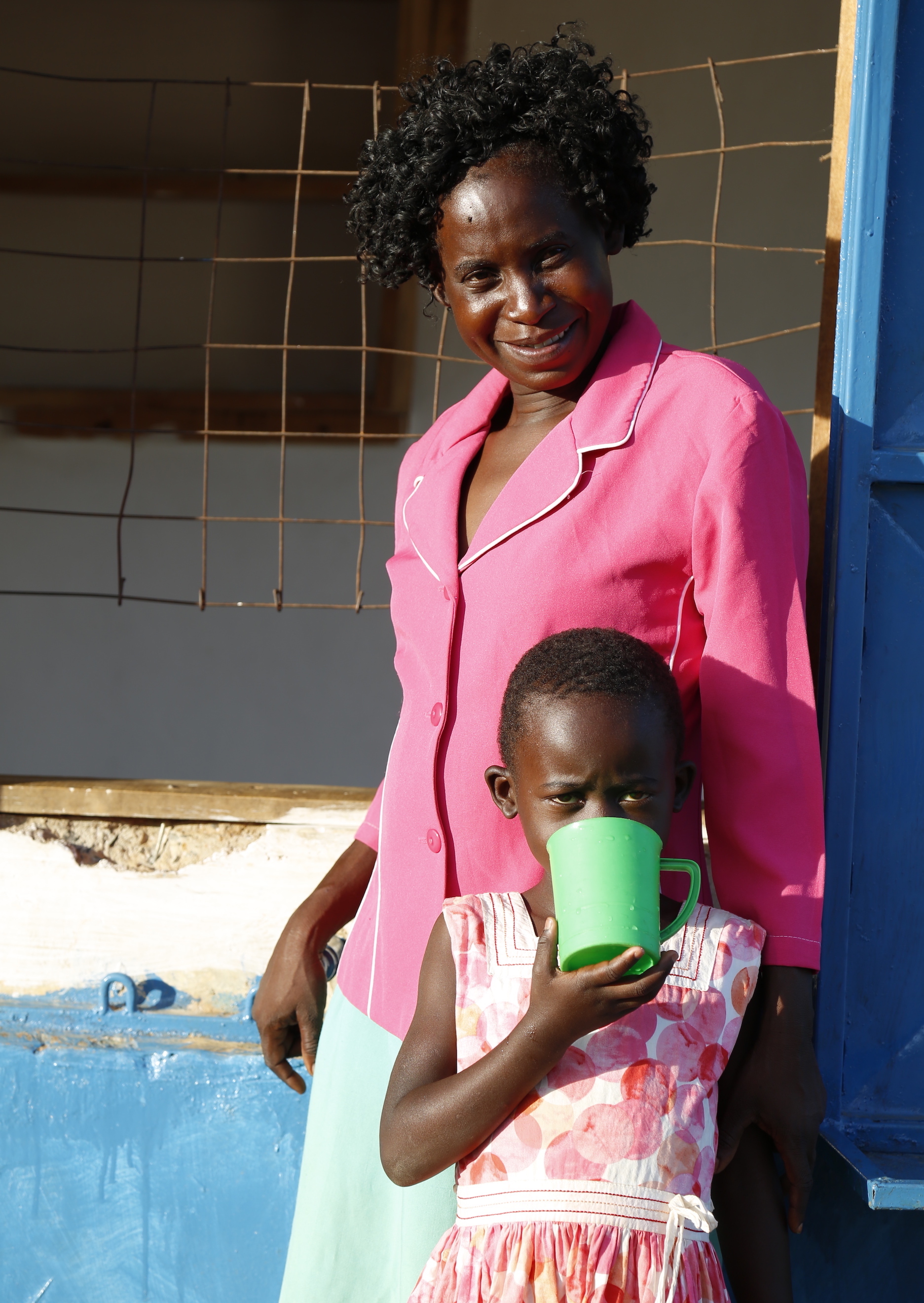 Joan's child enjoys clean water from a water kiosk constructed by World Vision in Angurai, Western Kenya. © World Vision/Photo by Susan Otieno.